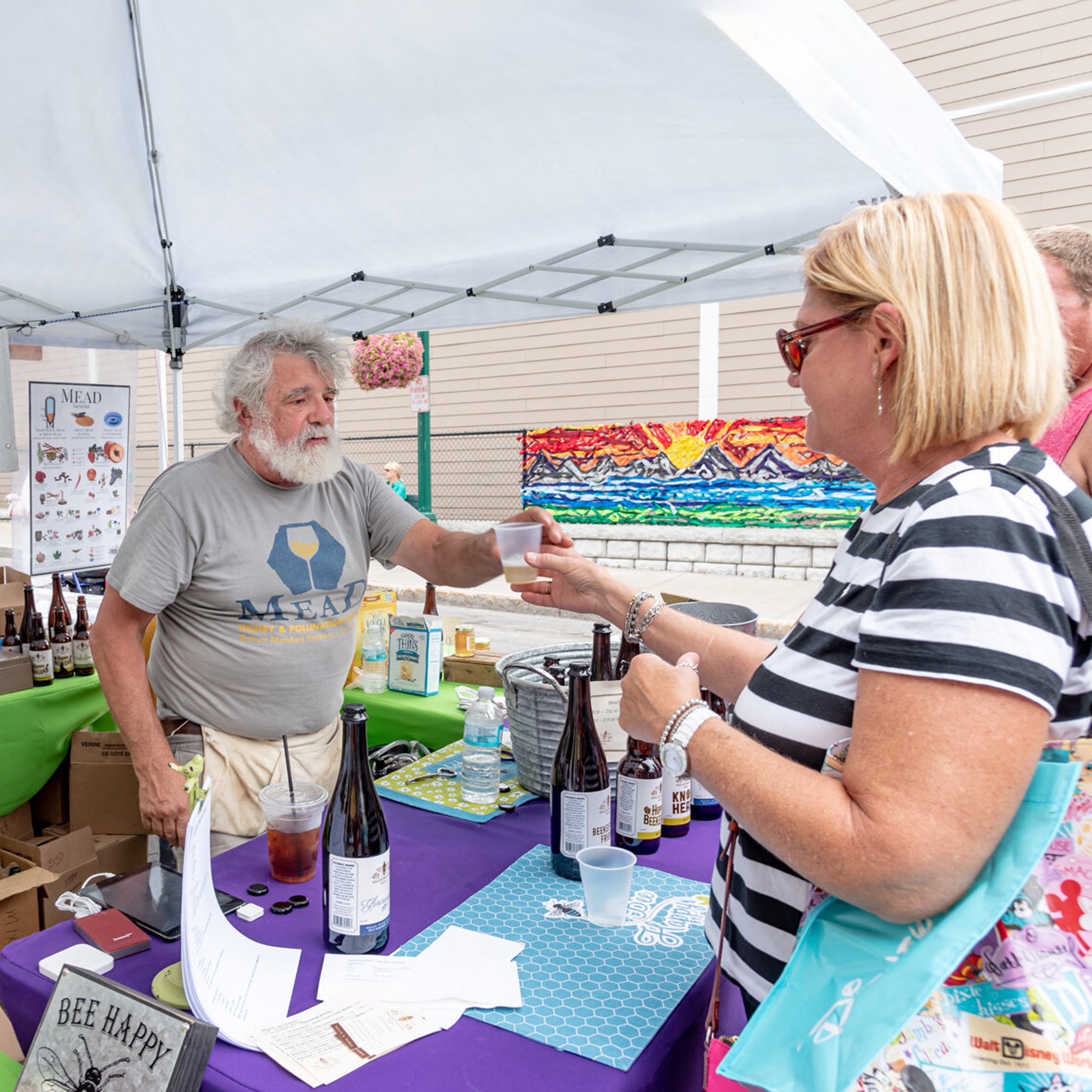  In event photography, a customer purchases from a vendor at a street fair. 