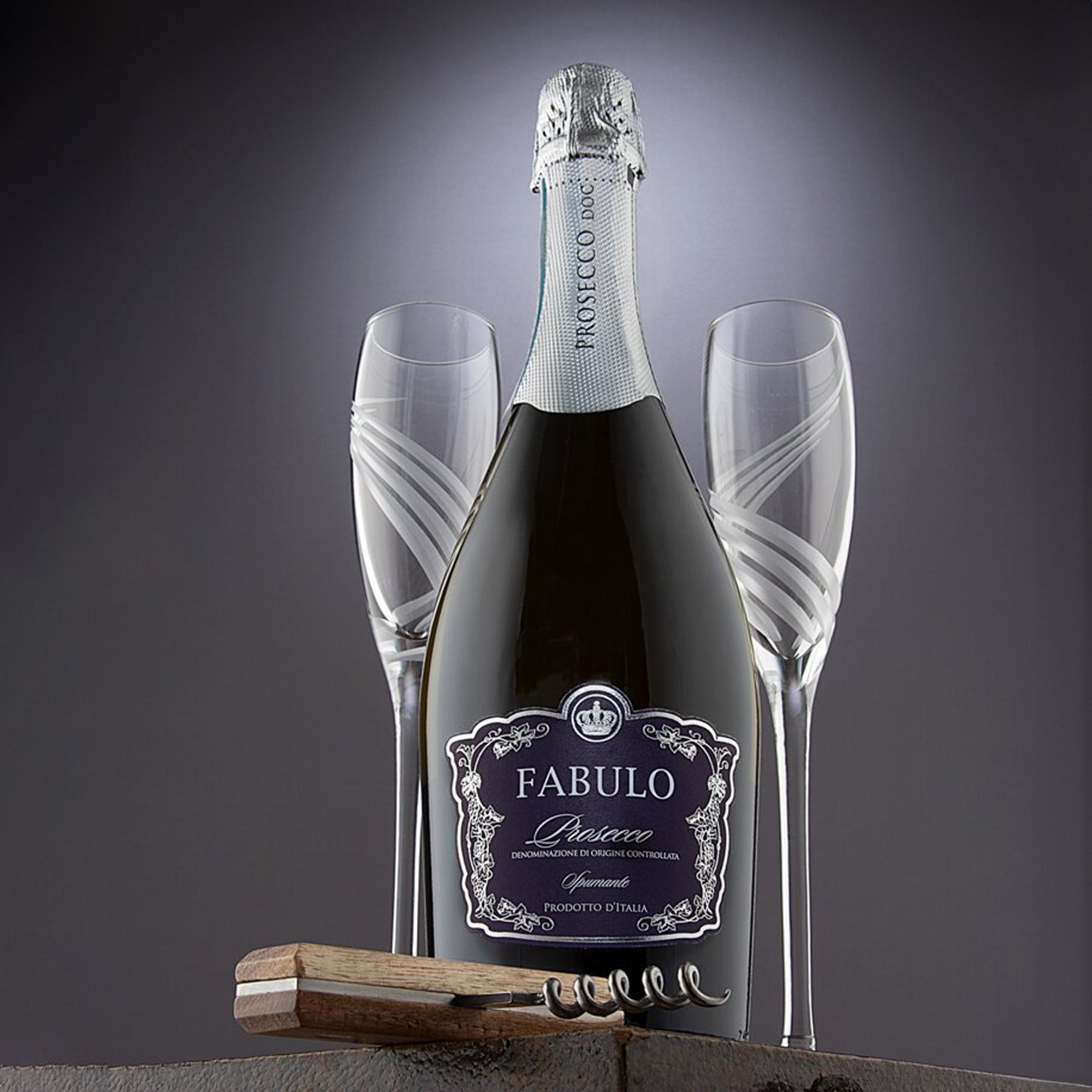  a bottle of champagne bottle and 2 glasses on a leather case with a light gray background 