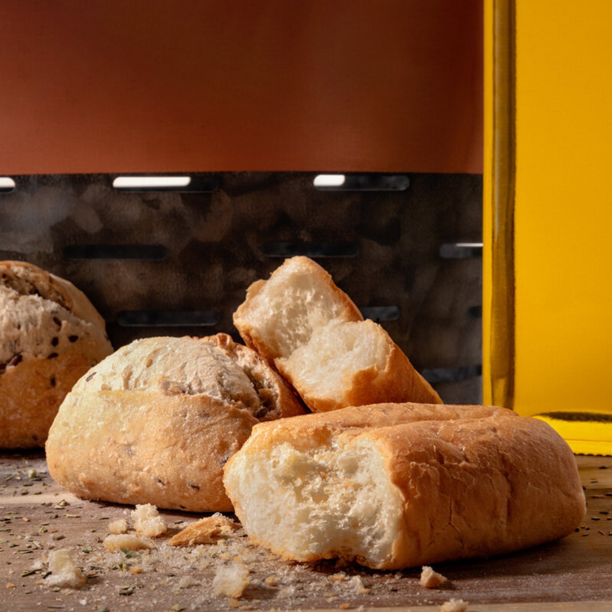  Freshly baked bread on a cutting board and olive oil on the side. professional food photography will show off your food and make it look ready to eat. 
