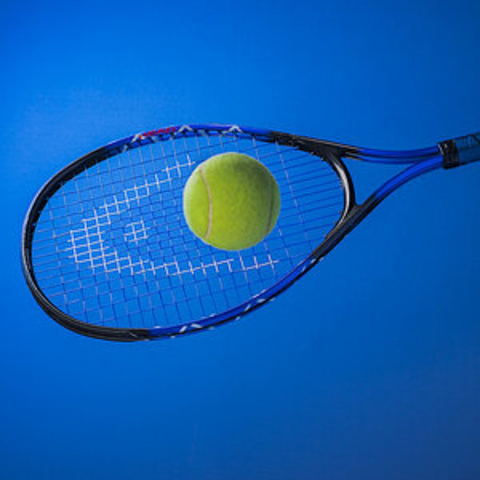  tennis racket hitting a tennis ball against a blue bacground 