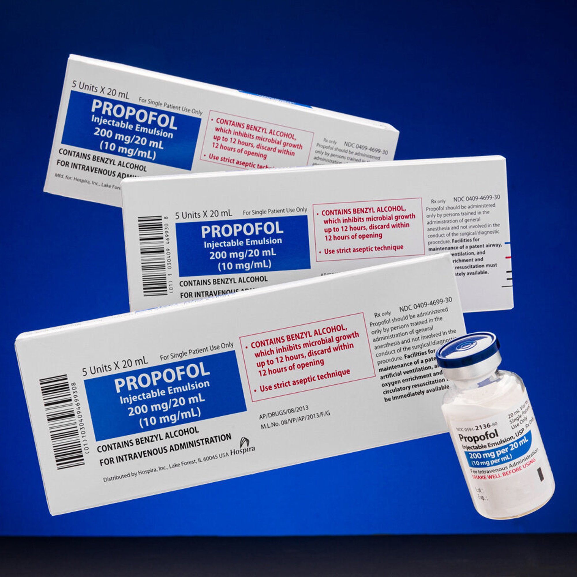  Medical anesthetic propofol was photographed showing off product packaging and the bottle of the drug against a bright blue background matching the brand’s coloring. 