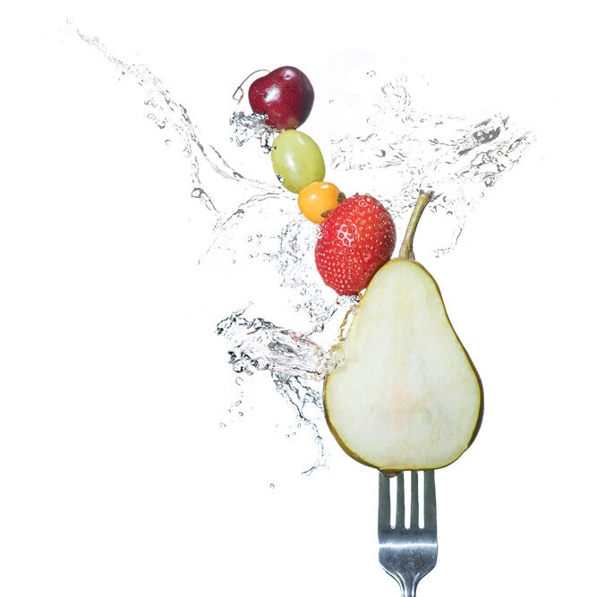  Several fruits on a fork being splashed with water give a feeling of freshness. Pear grapes and tomatoes  