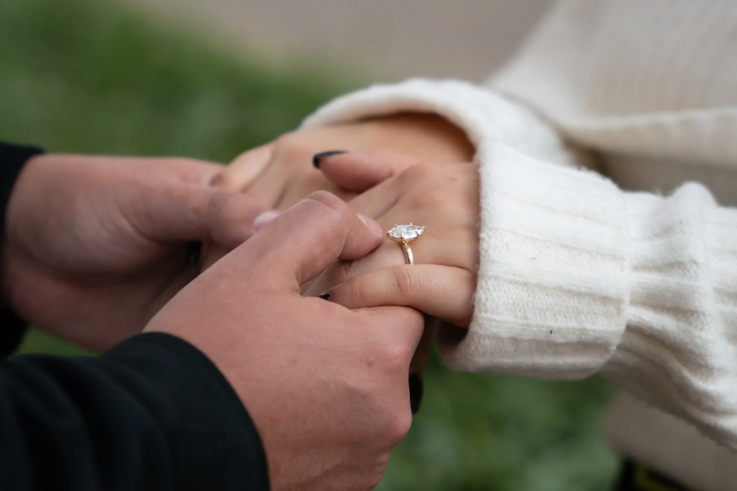 An engagement ring being placed on a finger