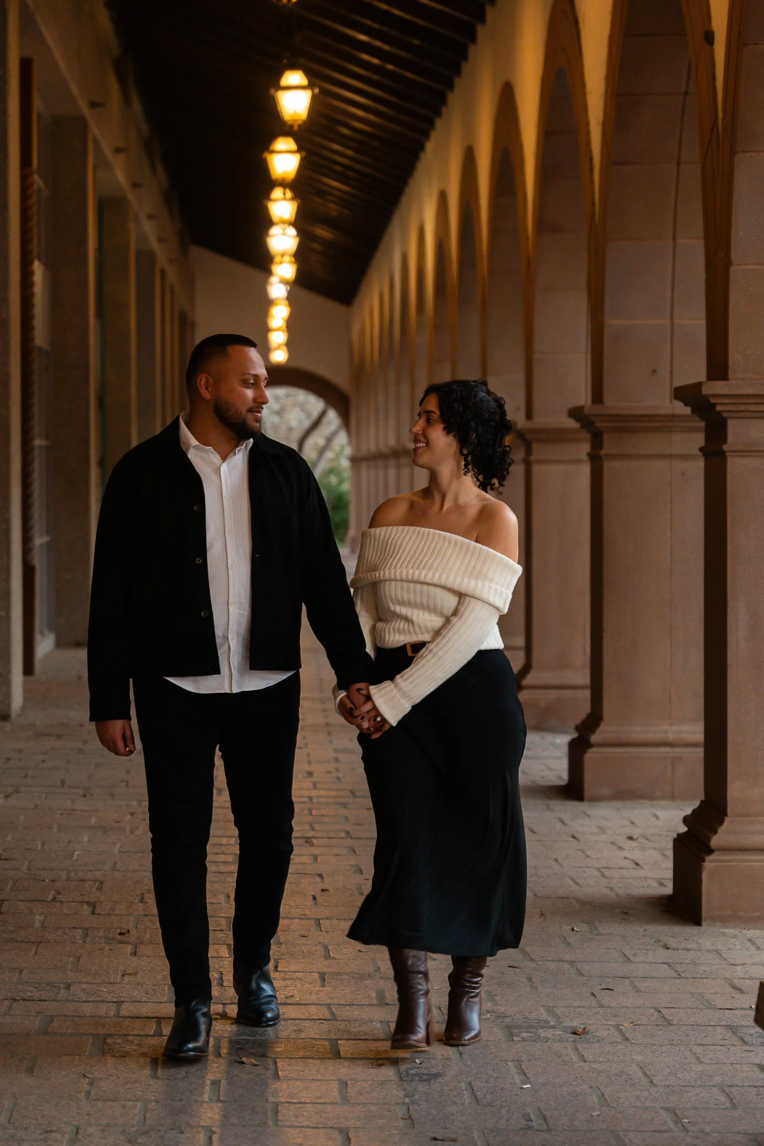Engaged couple walking together at sunset