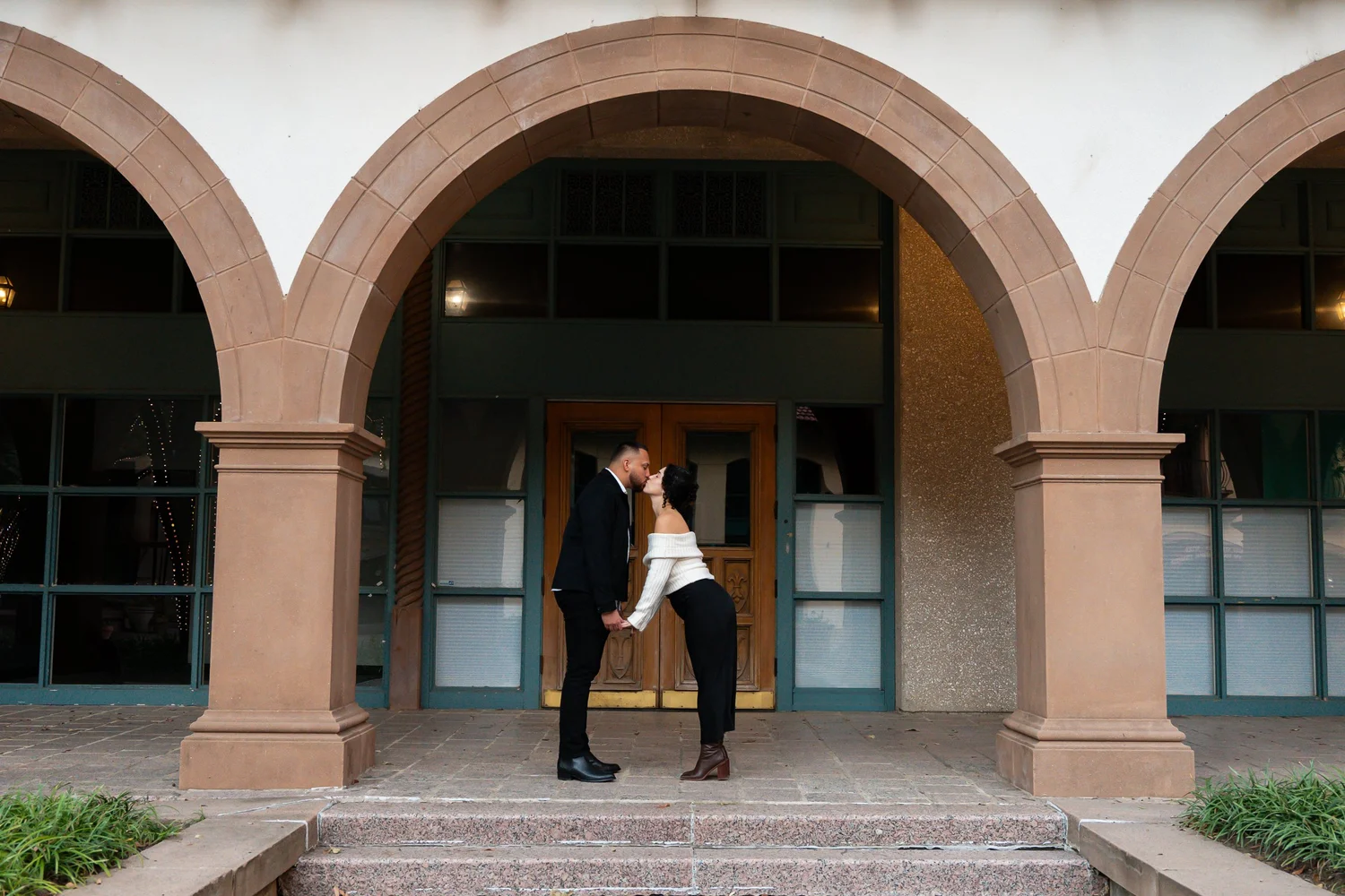 Engaged couple beneath an archway