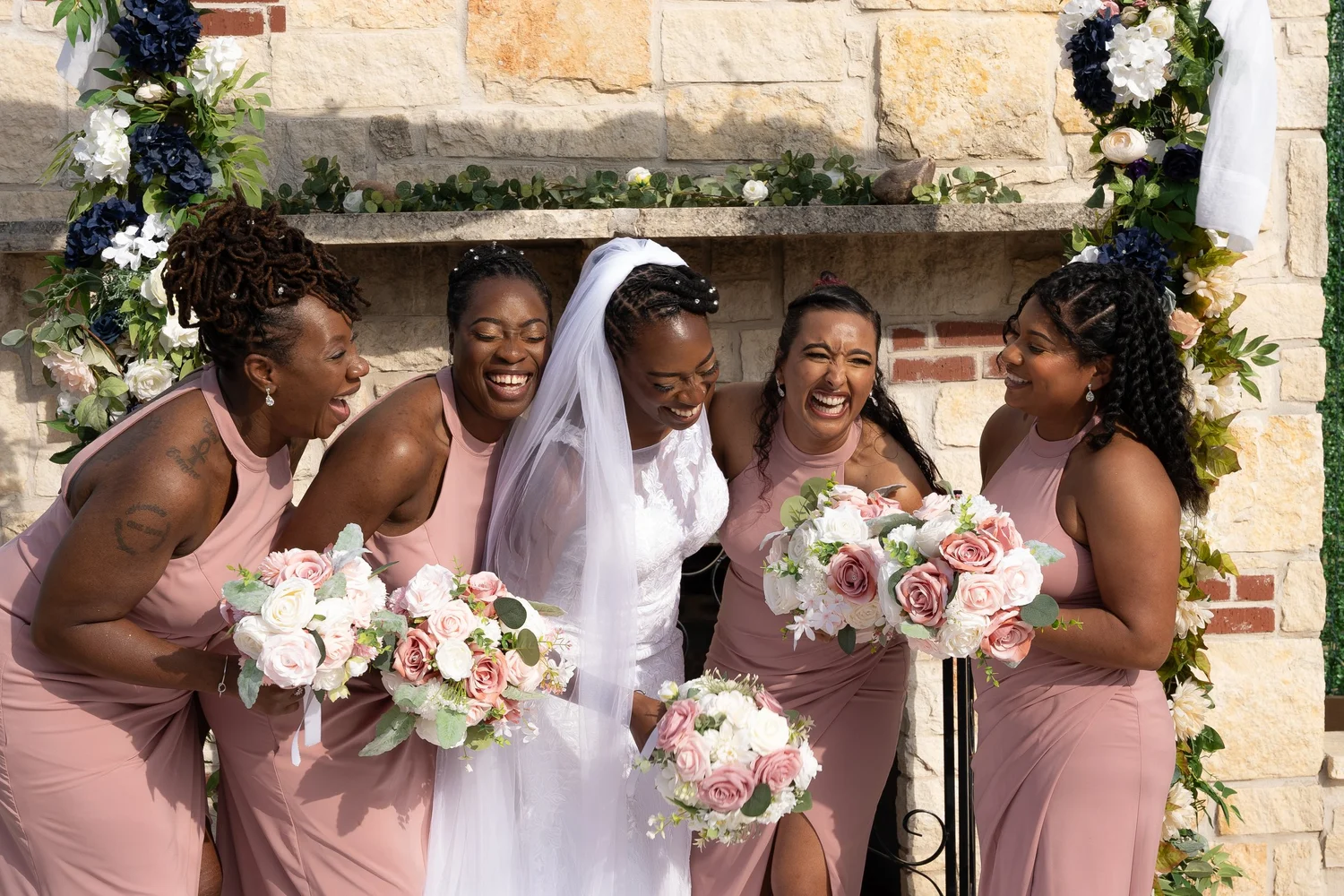 Bride laughing with her bridesmaids