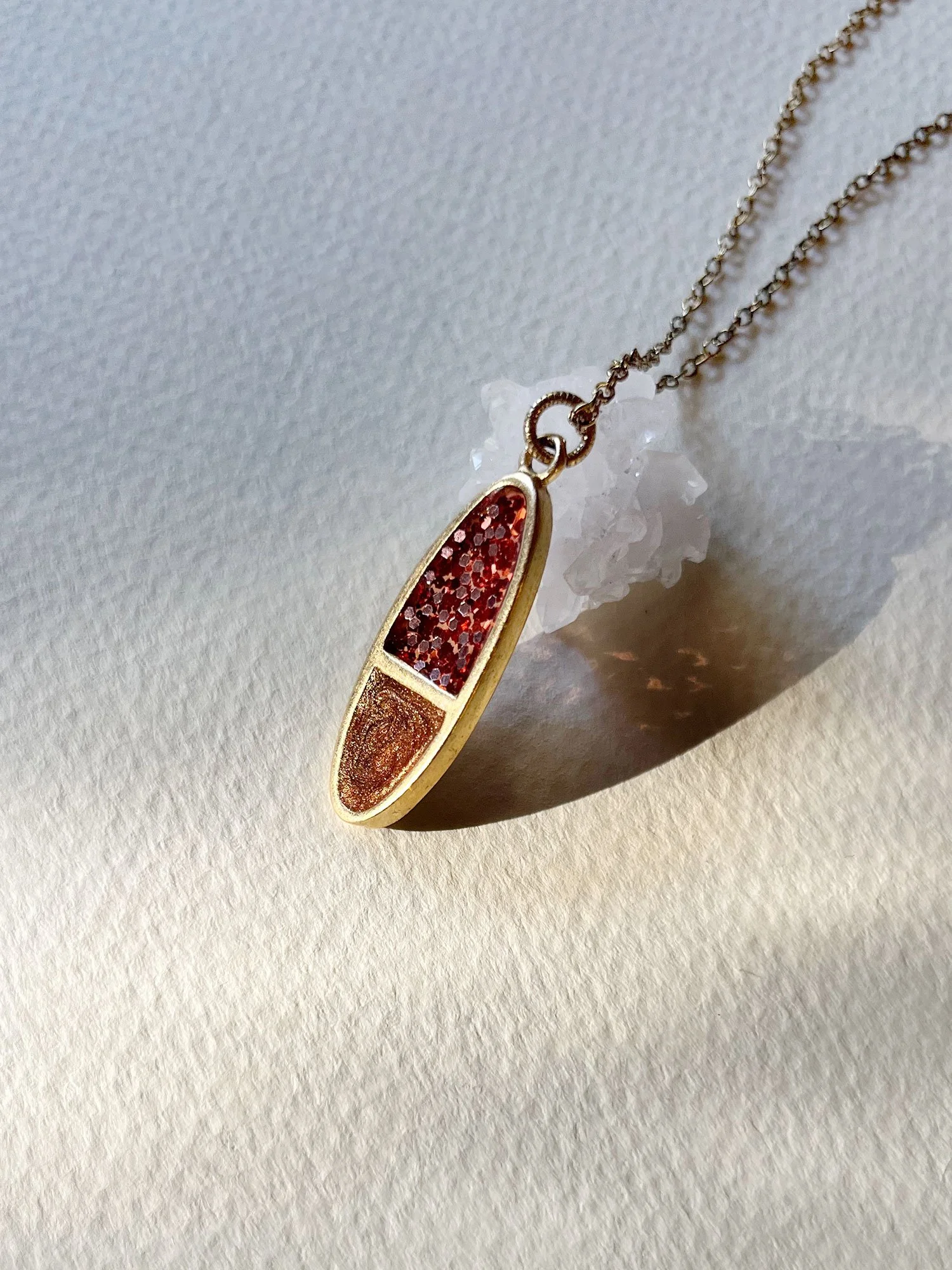 Side angle of Tuesday Necklace leaning against quartz