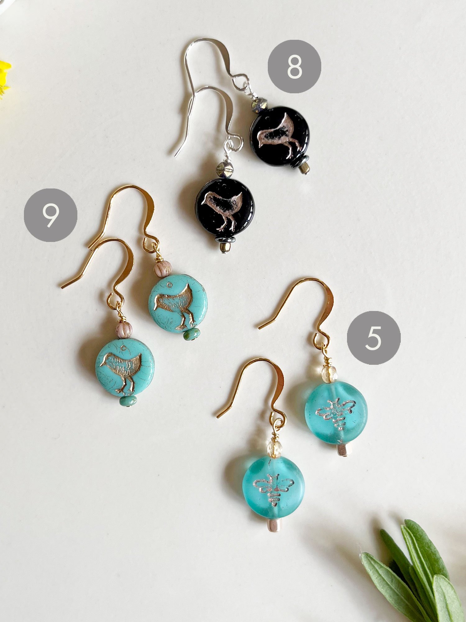 Bird earrings in turquoise and black and bee earrings in aqua