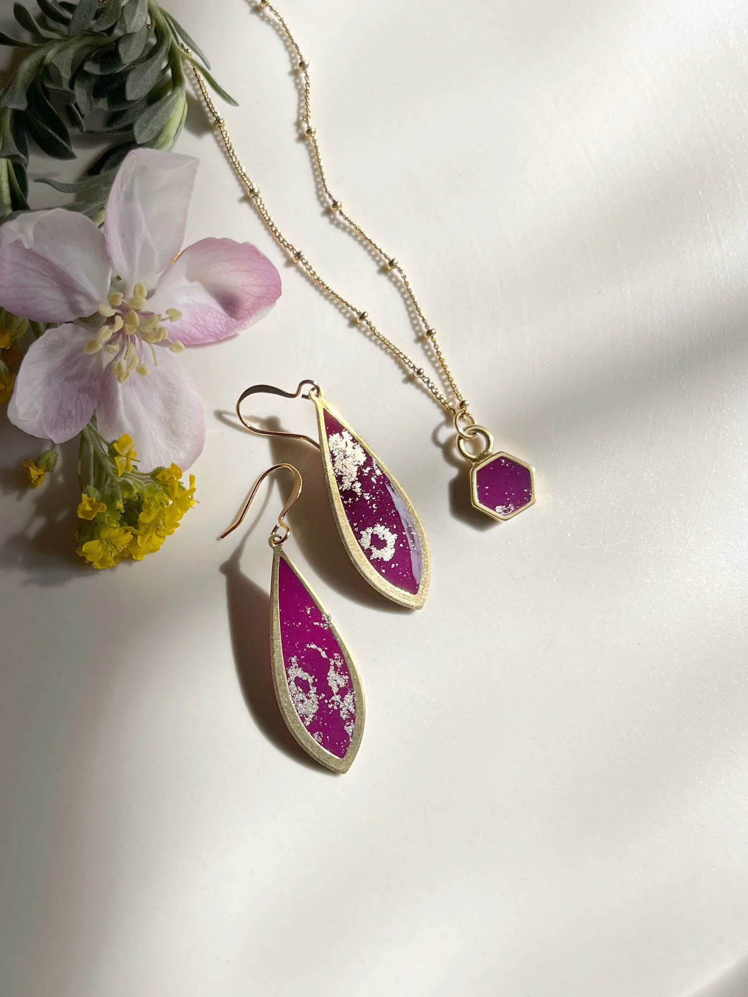 Cascading heart earrings in pink and gold.