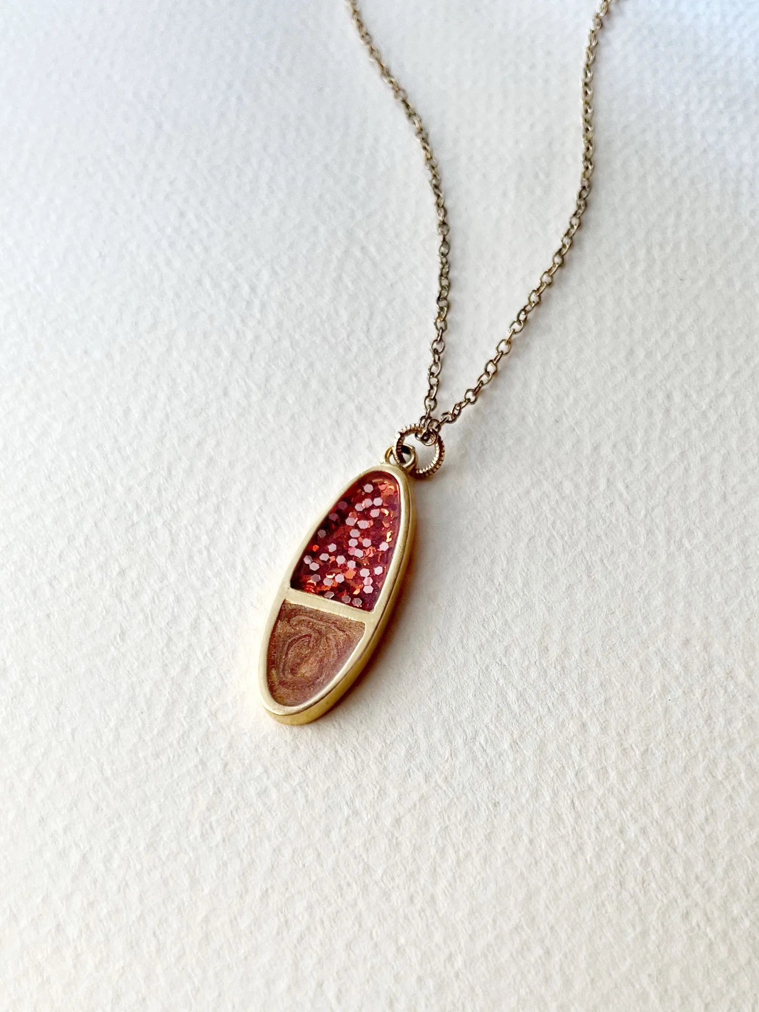 Oval Tuesday Necklace in gold, copper, and sparkly orange.