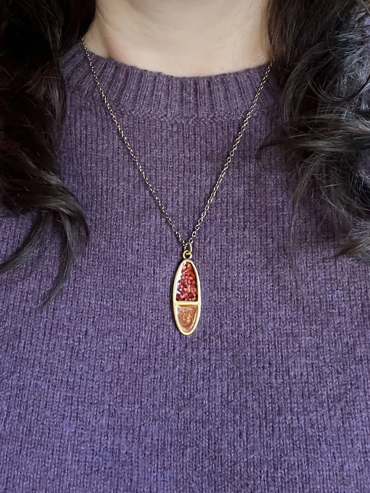 Model in purple sweater wearing the gold Tuesday Necklace