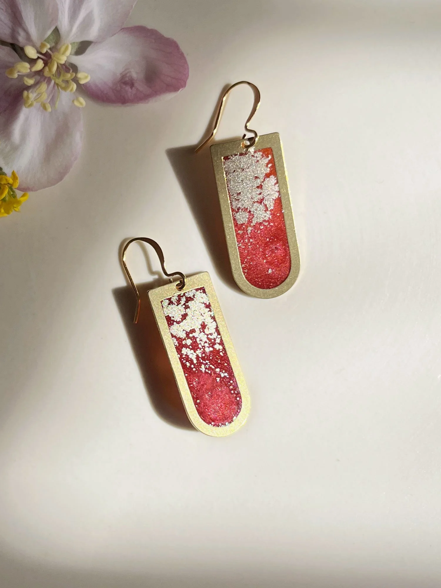 Brass earrings filled with brick red resin and gold dust