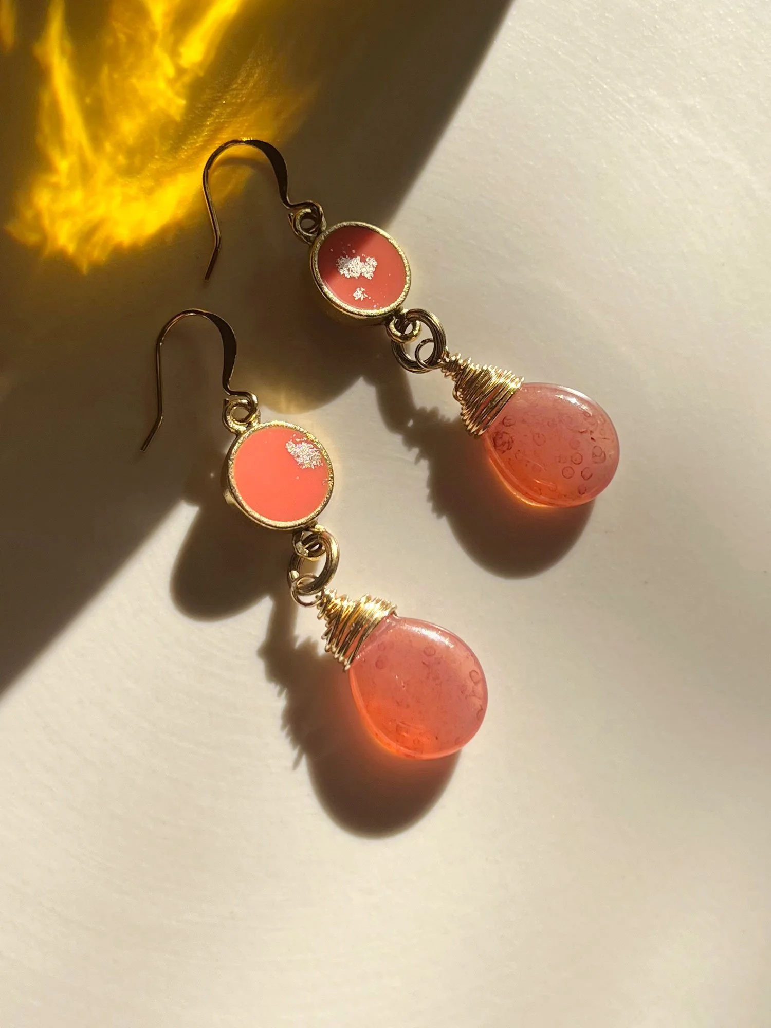 Shangri-la Earrings in sweet peach in strong sunlight