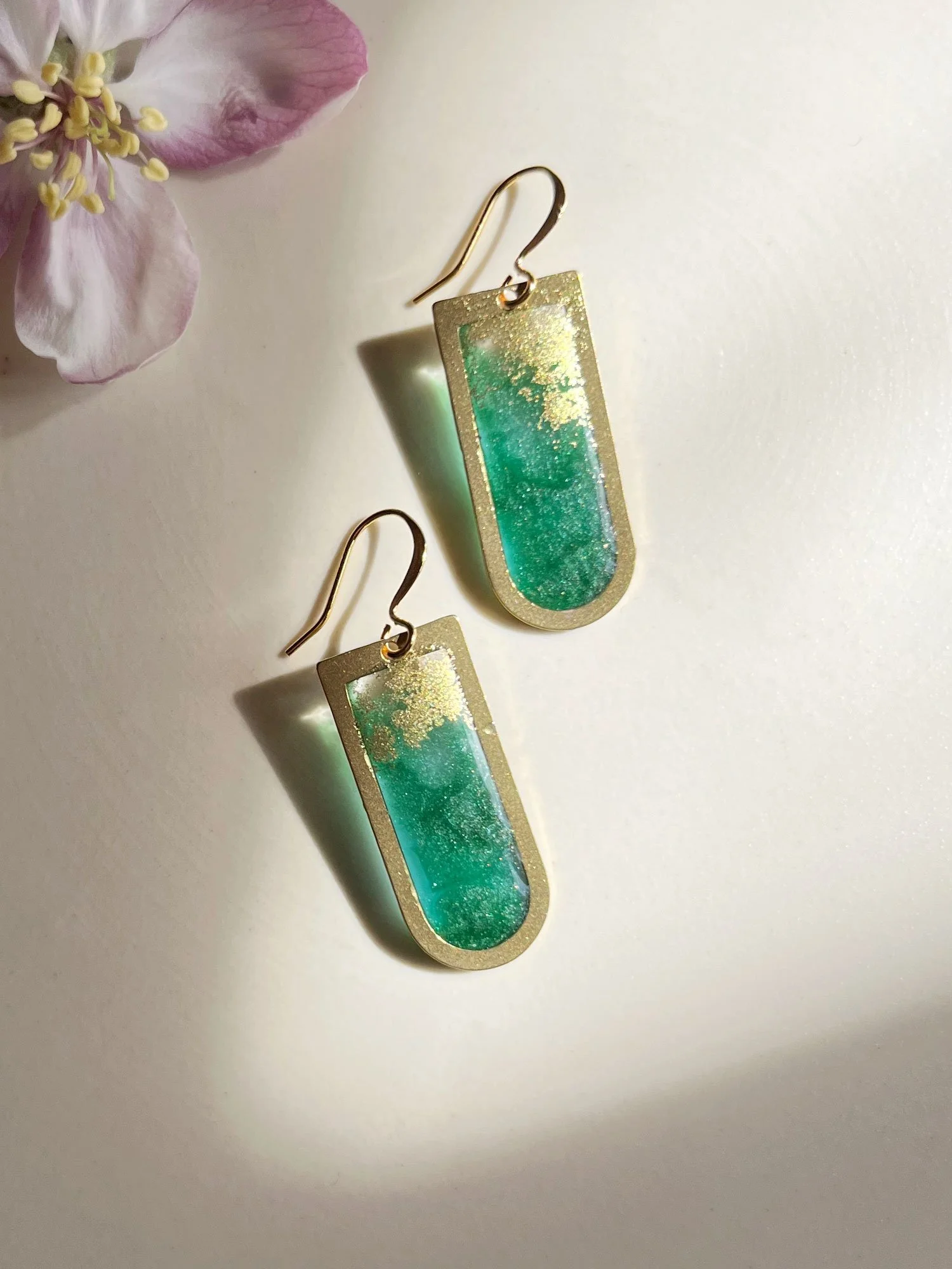 Brass earrings filled with kelly green resin and gold dust