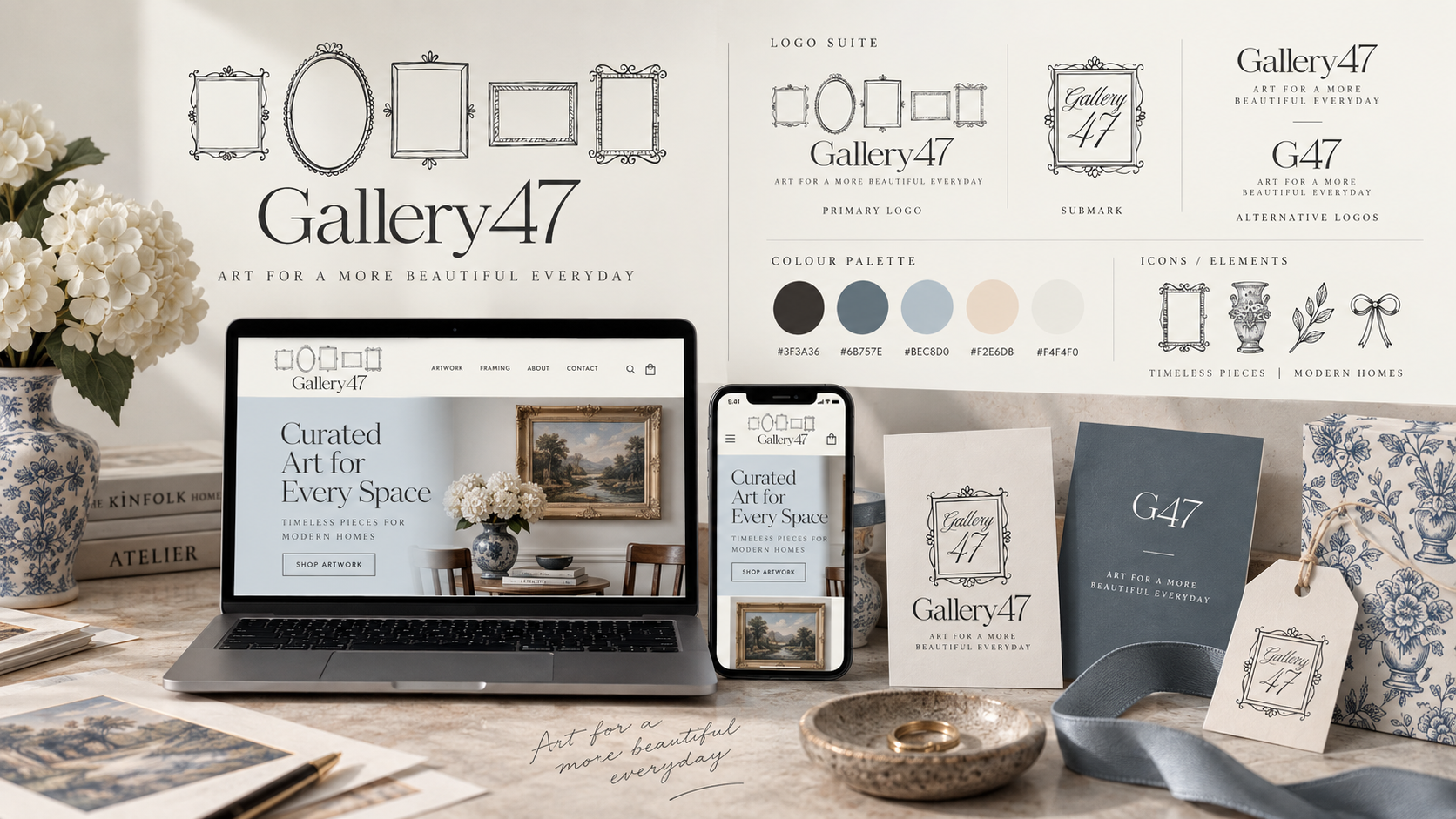 A display of branding and marketing materials for Gallery47, an art brand, on a workspace. The scene includes a laptop and a smartphone showing the website, decorative picture frames, a potted plant with white flowers, and promotional cards with the logo and artwork. The background features a large poster with the brand logo, color palette, and design elements.