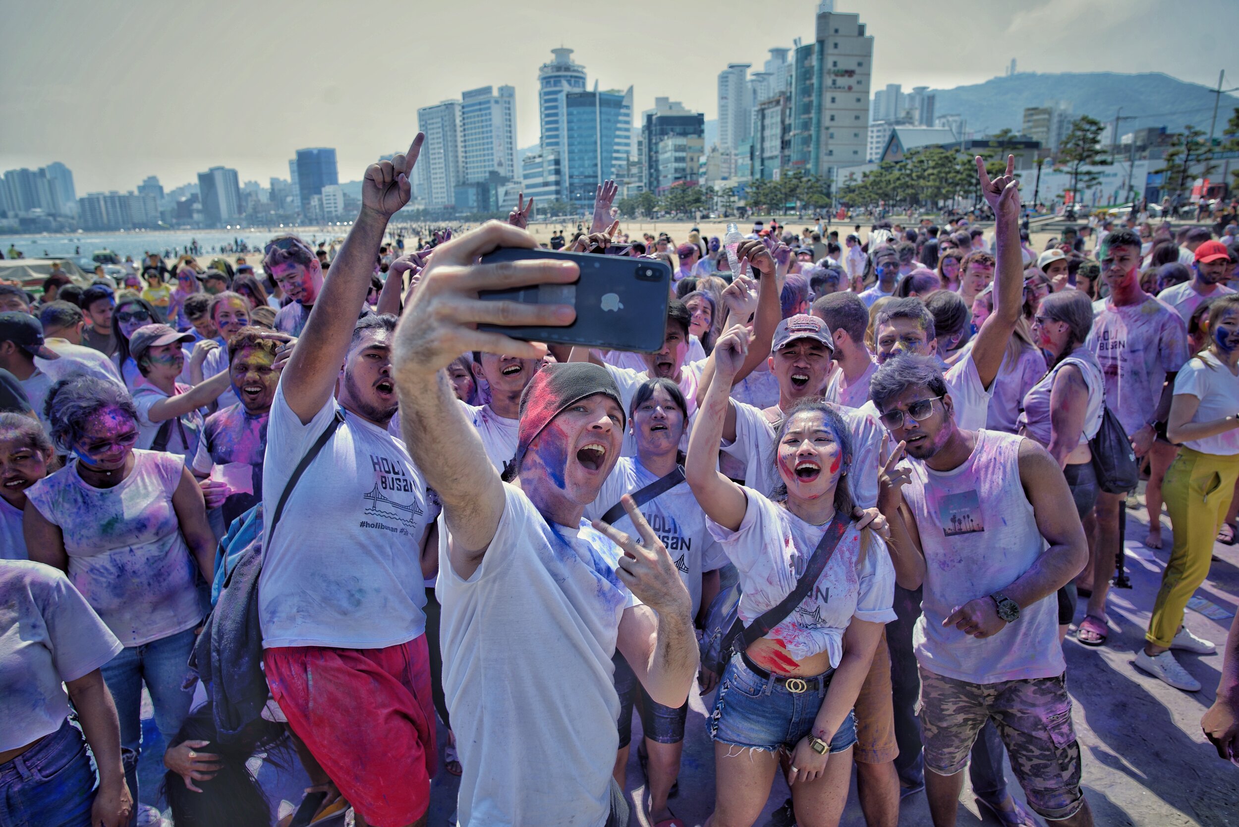 Local celebrity Chad Kirton,  who  was the MC for the Gwangan Beach  Holi Hai  event in 2019 takes a breif moment from MC'ing to pose for a photo with fans.  (Busan , South  Korea)  