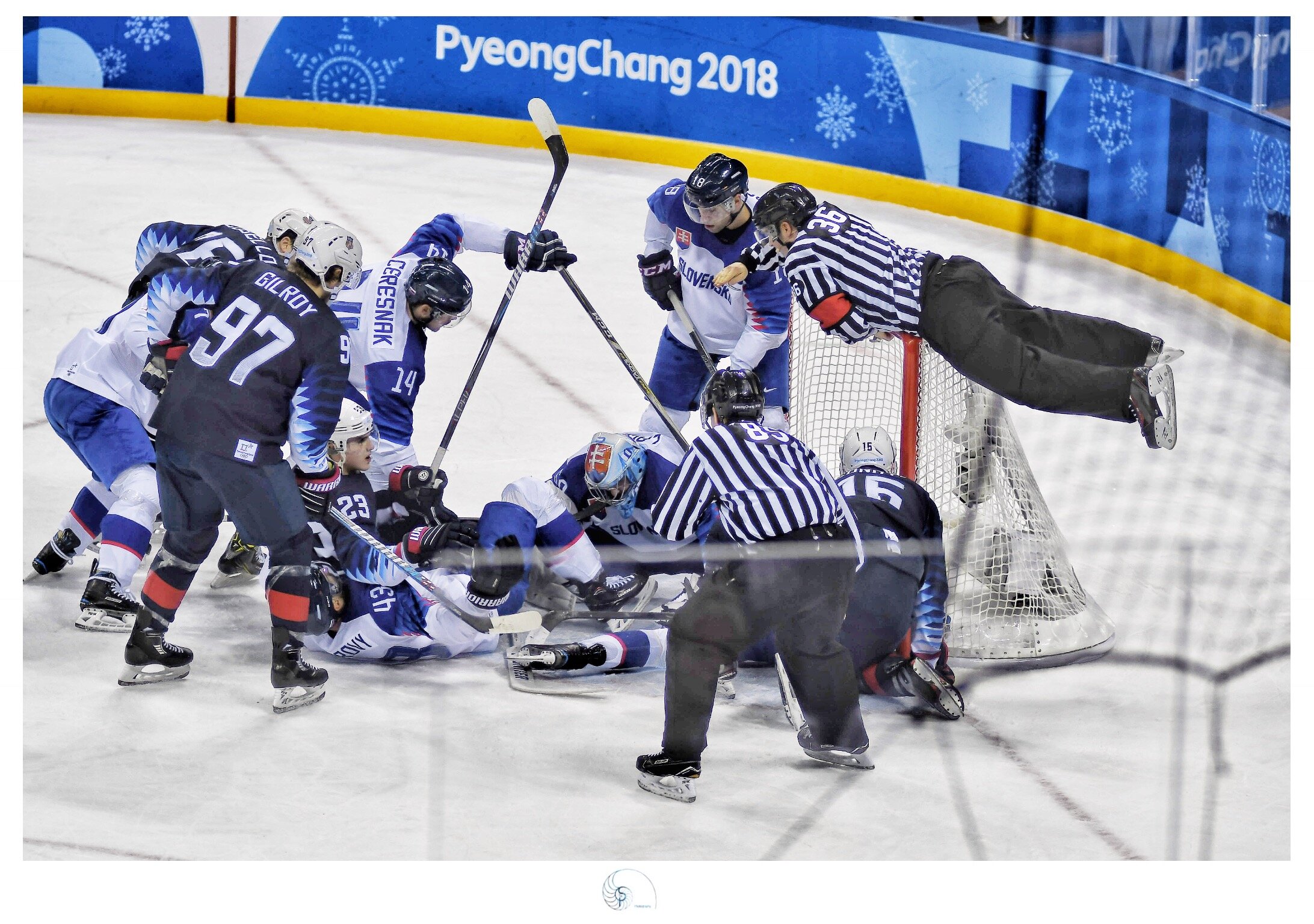 A Ref. jumps on top of the net during the U.S. Slovakia men's Hockey game during the 2018 Winter Olympics held in Pyoung-Chang South Korea.