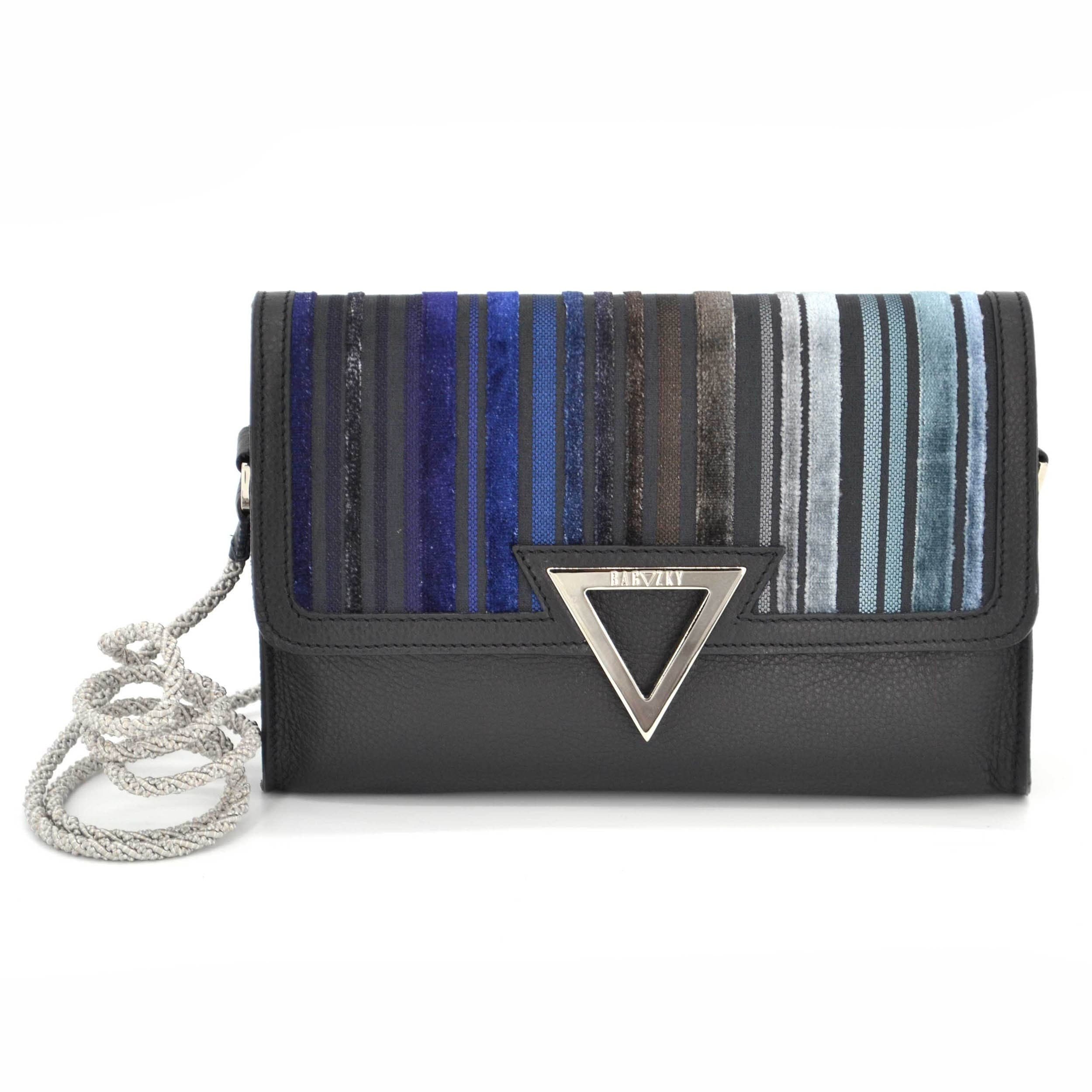 Front view on the small black leather clutch purse. The black leather is combined with furniture fabric in cold blueish to antracite tones.