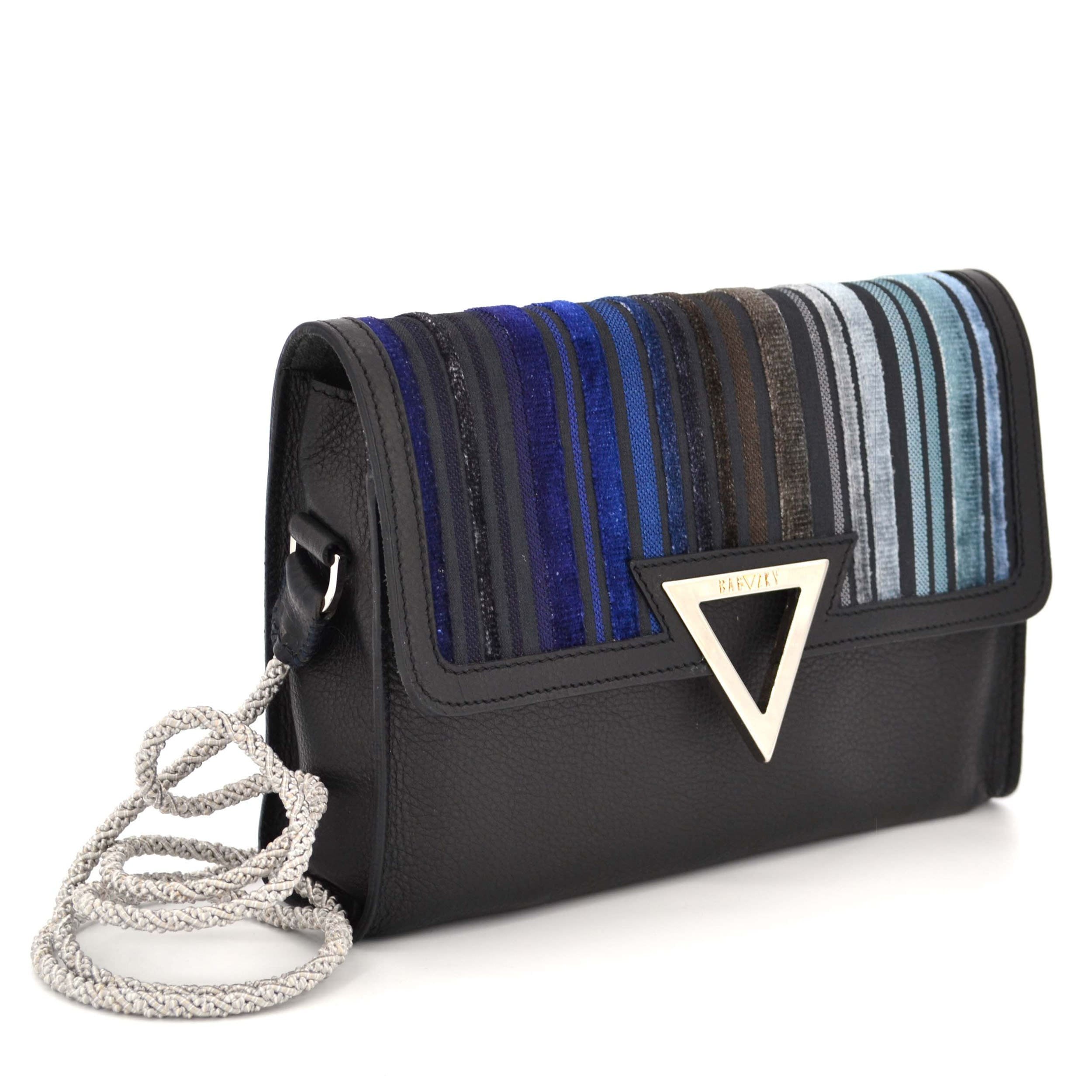 Side view of the Polar Tapezzeria Clutch from Bagazky. The upholstery fabric is a mix of velvet and plain fabric.