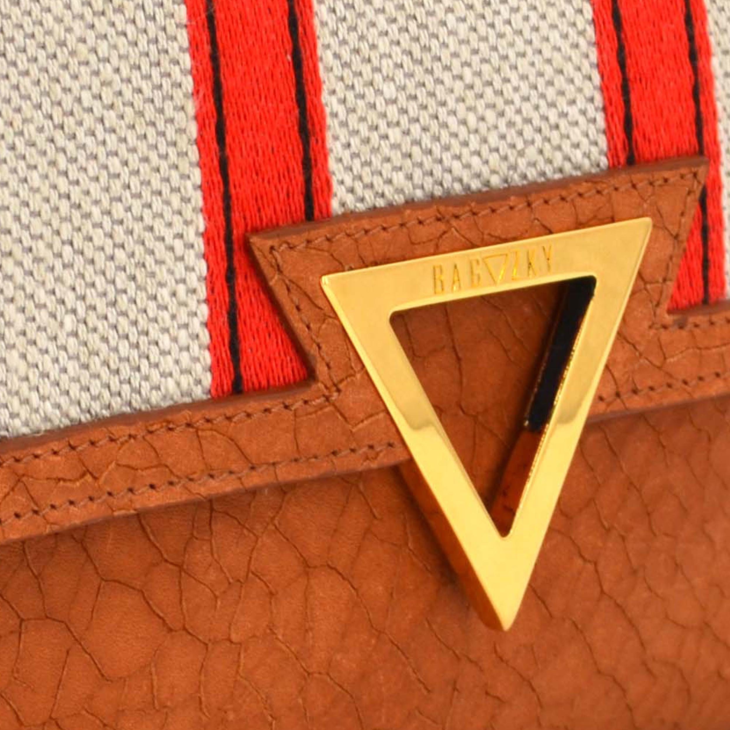 Detail where you can see the gold plated brass emblem with the BAGAZKY lettering engraved. Also the texture of the fabric is good to see.