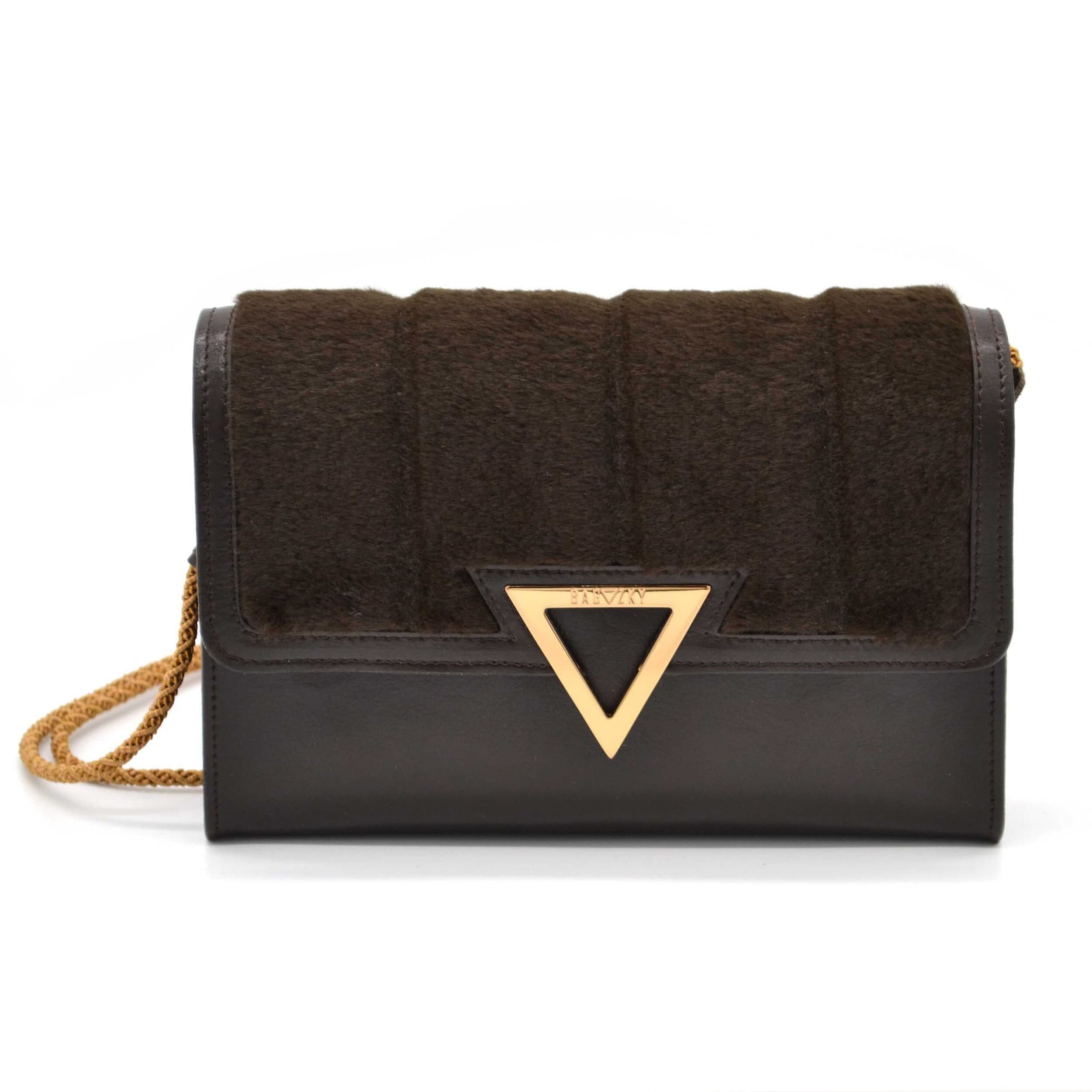 Dark brown leather purse with brown fur. Gold plated Bagazky emblem.