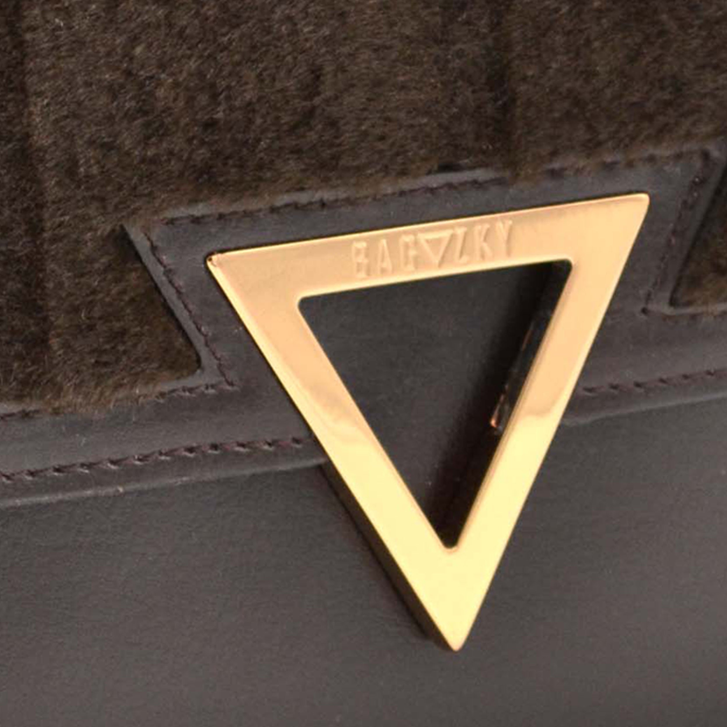 detailed view of the gold plated Bagazky Emblem, with engraved Bagazky lettering.