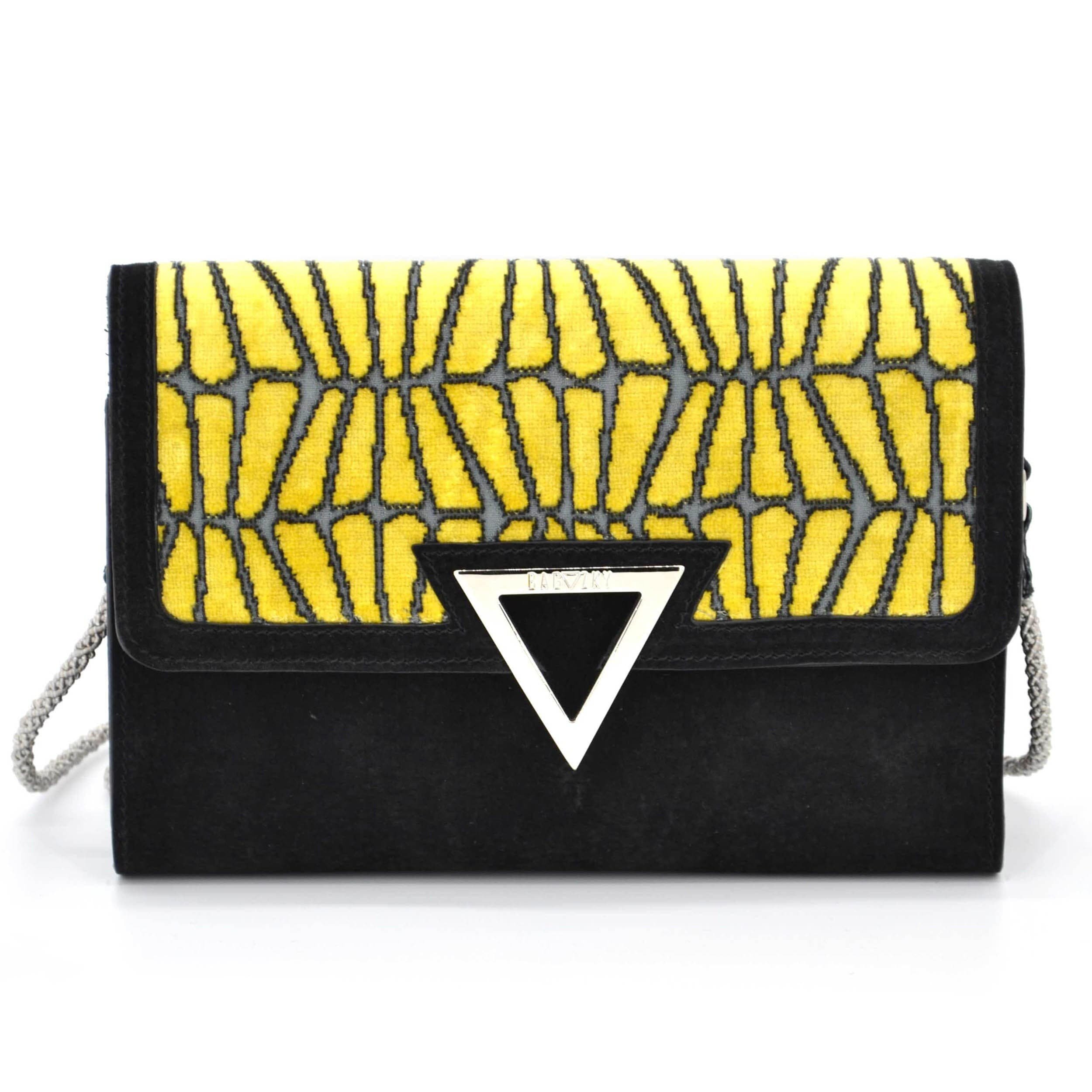 Front view of the black suede purse. It is combined with furniture fabric, that has yellow velvet patterns. If you combinde the different parts of the fabric, you may see the candy cracker.