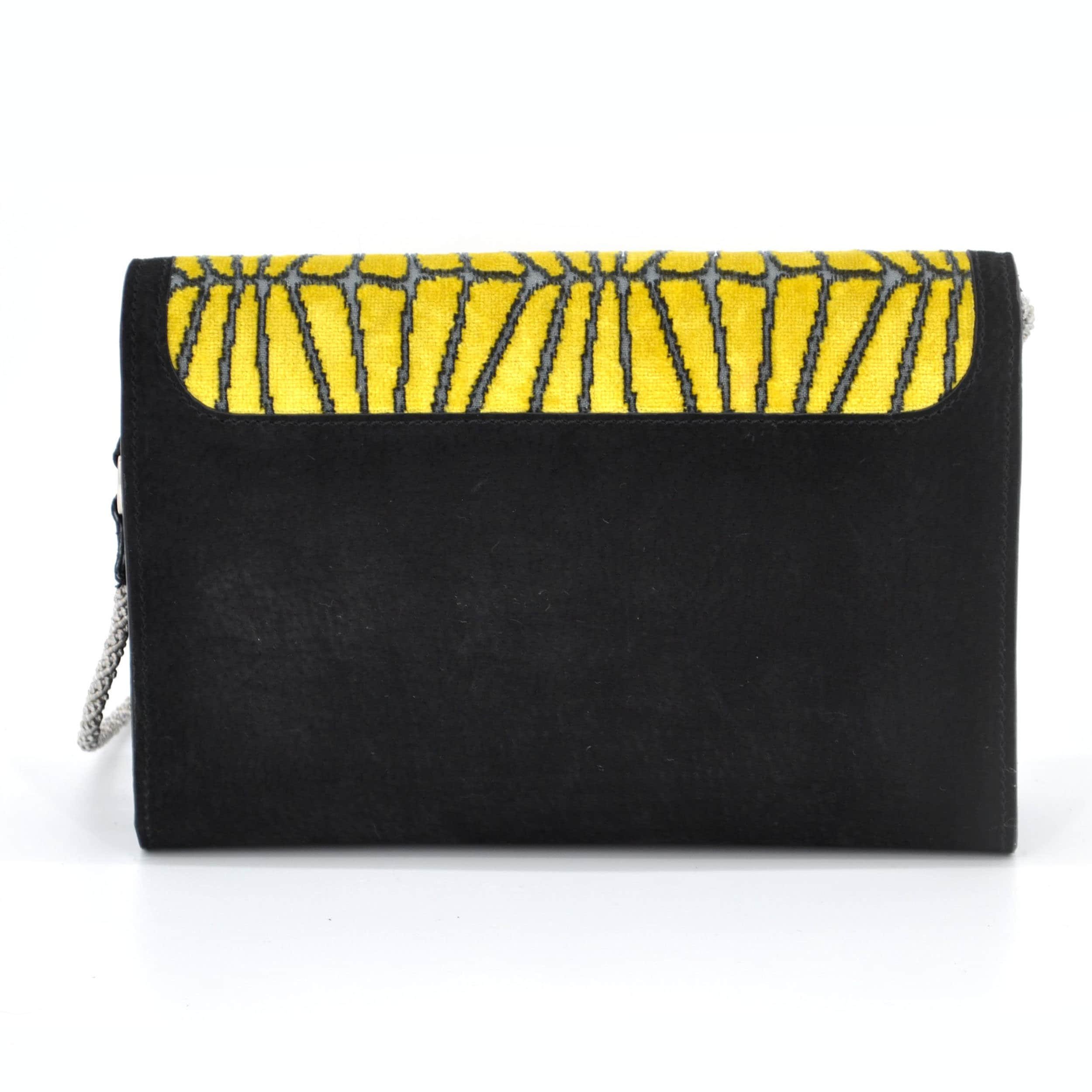 Back view of the Candy Cracker Tappezzeria Purse. It´s made of black suede and is combined with yellow upholstery velvet.