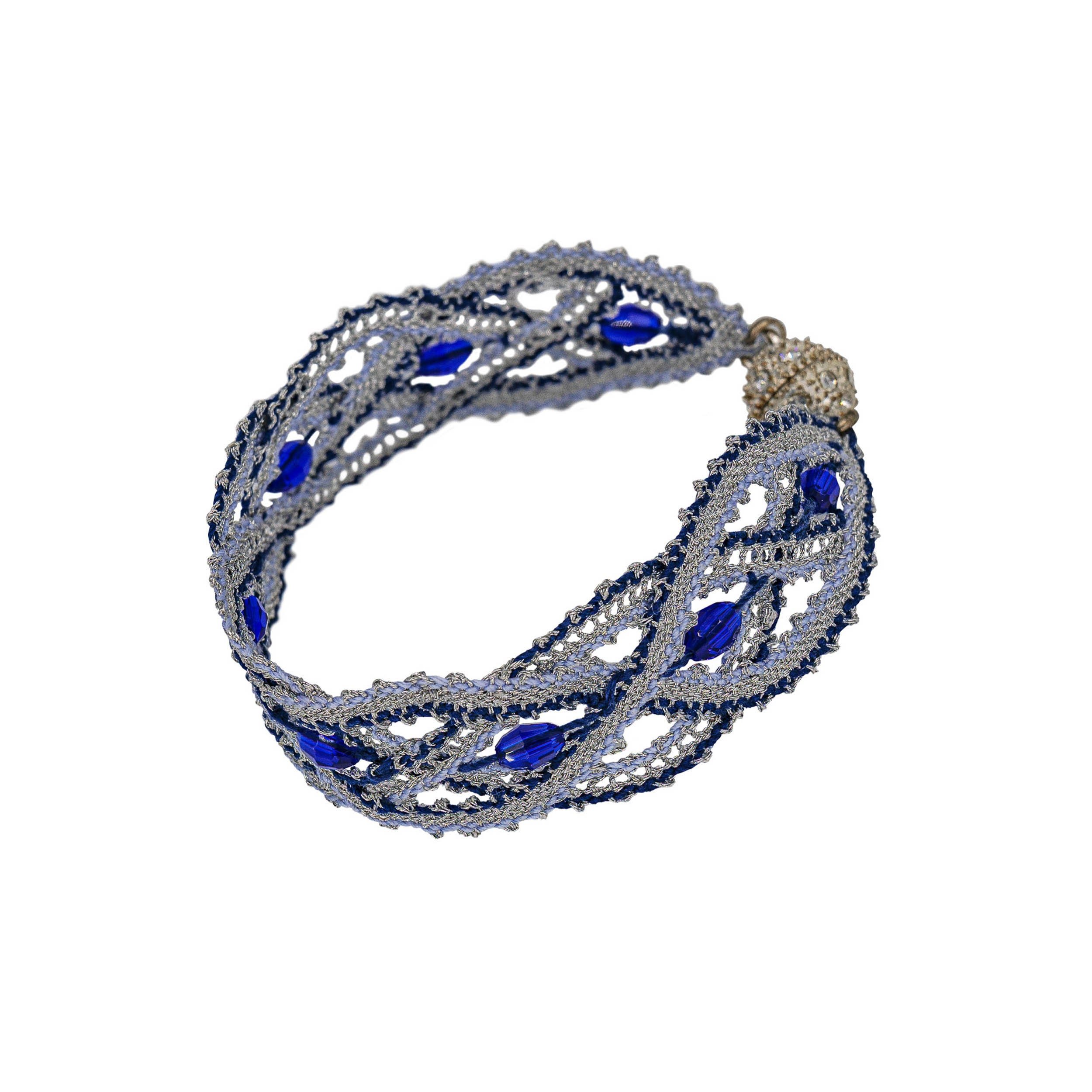 Sicilian lace wristband with a shape that is reminiscent of waves. Blue glass beads and fine cotton thread