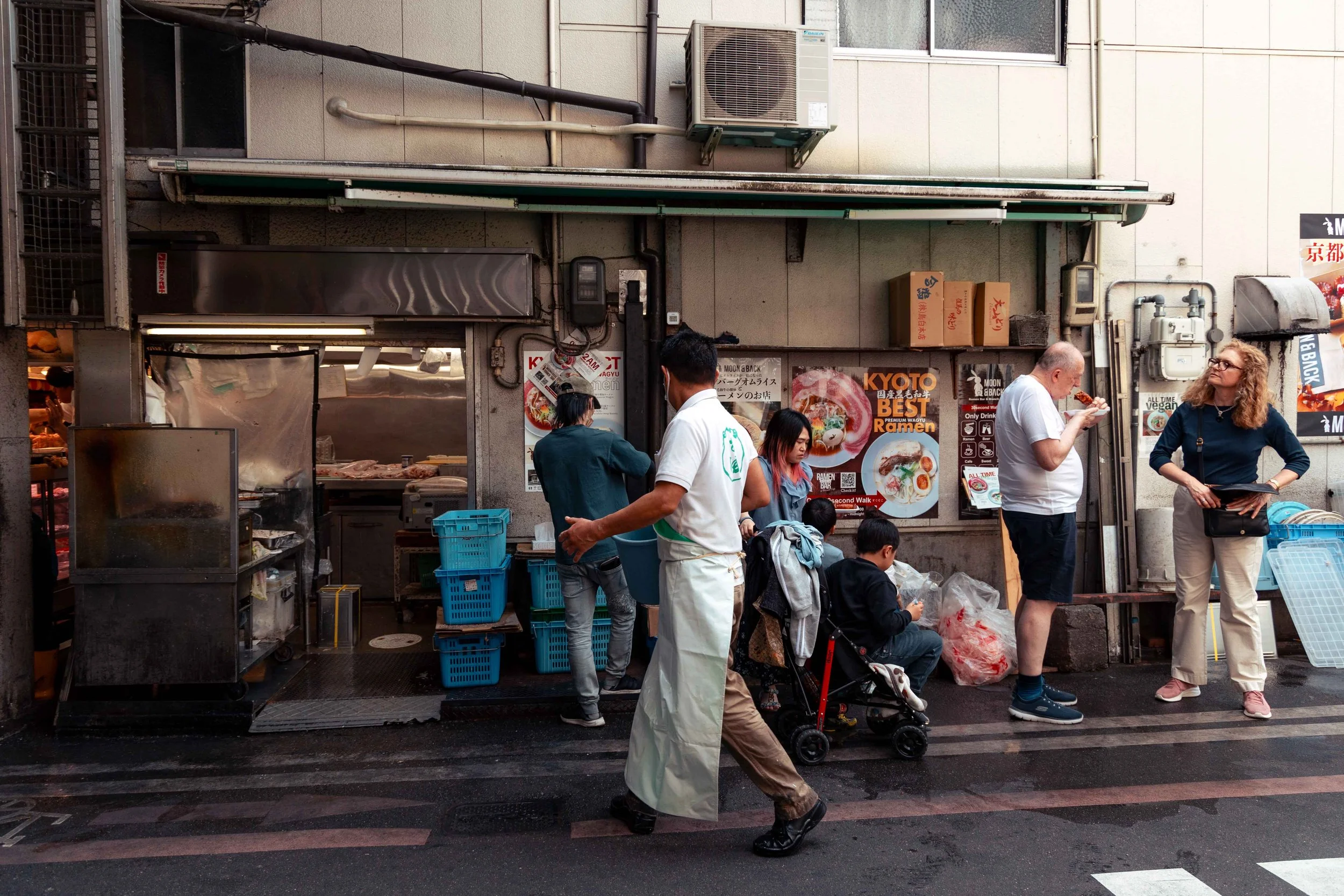 people eating on the street at Nishiki Market in Kyoto