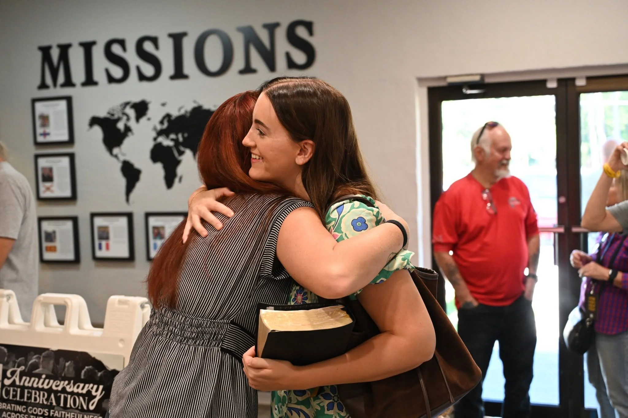 People connecting before service at East Bay Church near Navarre and Gulf Breeze