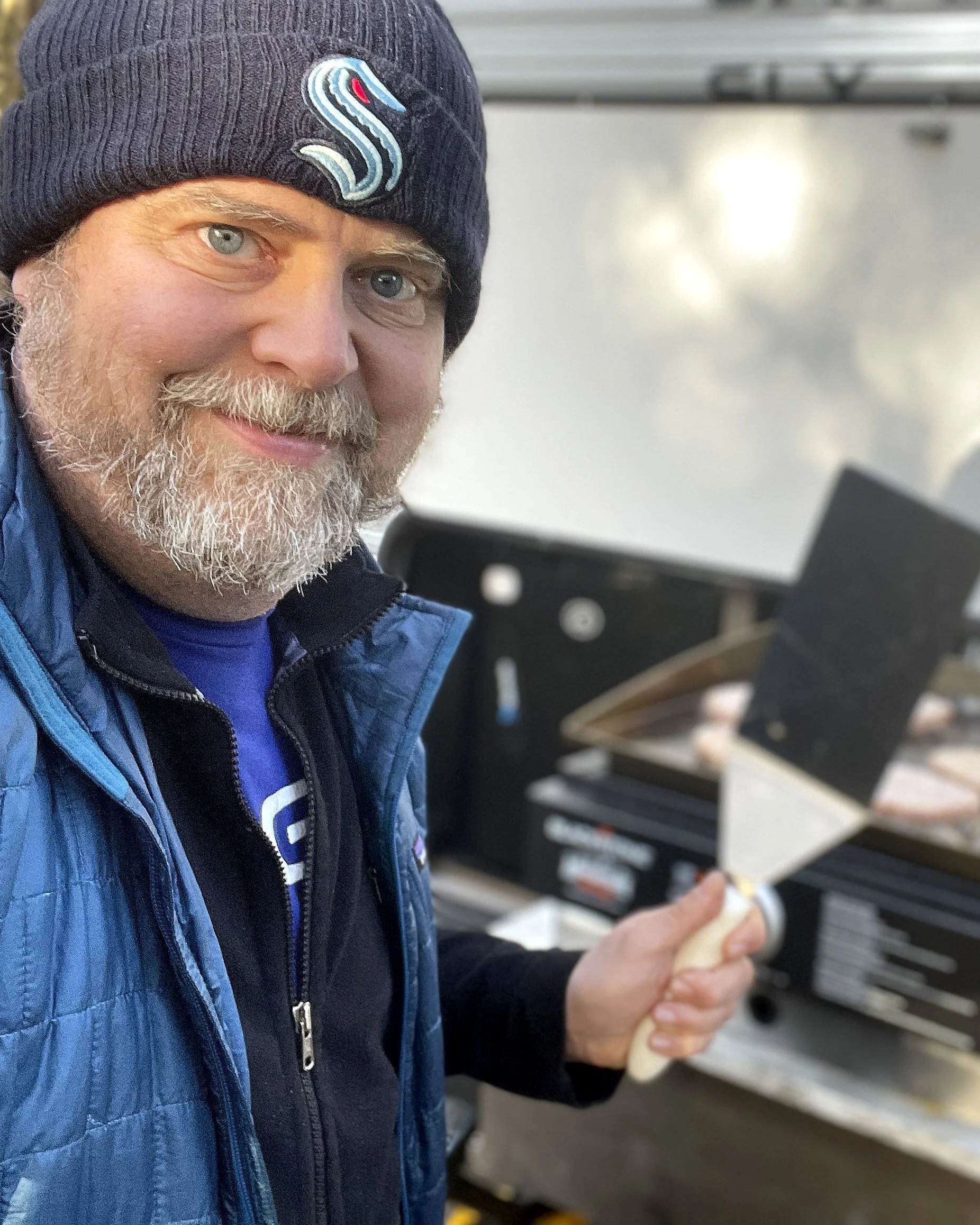 RV Out West podcast host, Brooks, cooking on his camp kitchen outside of his RV.