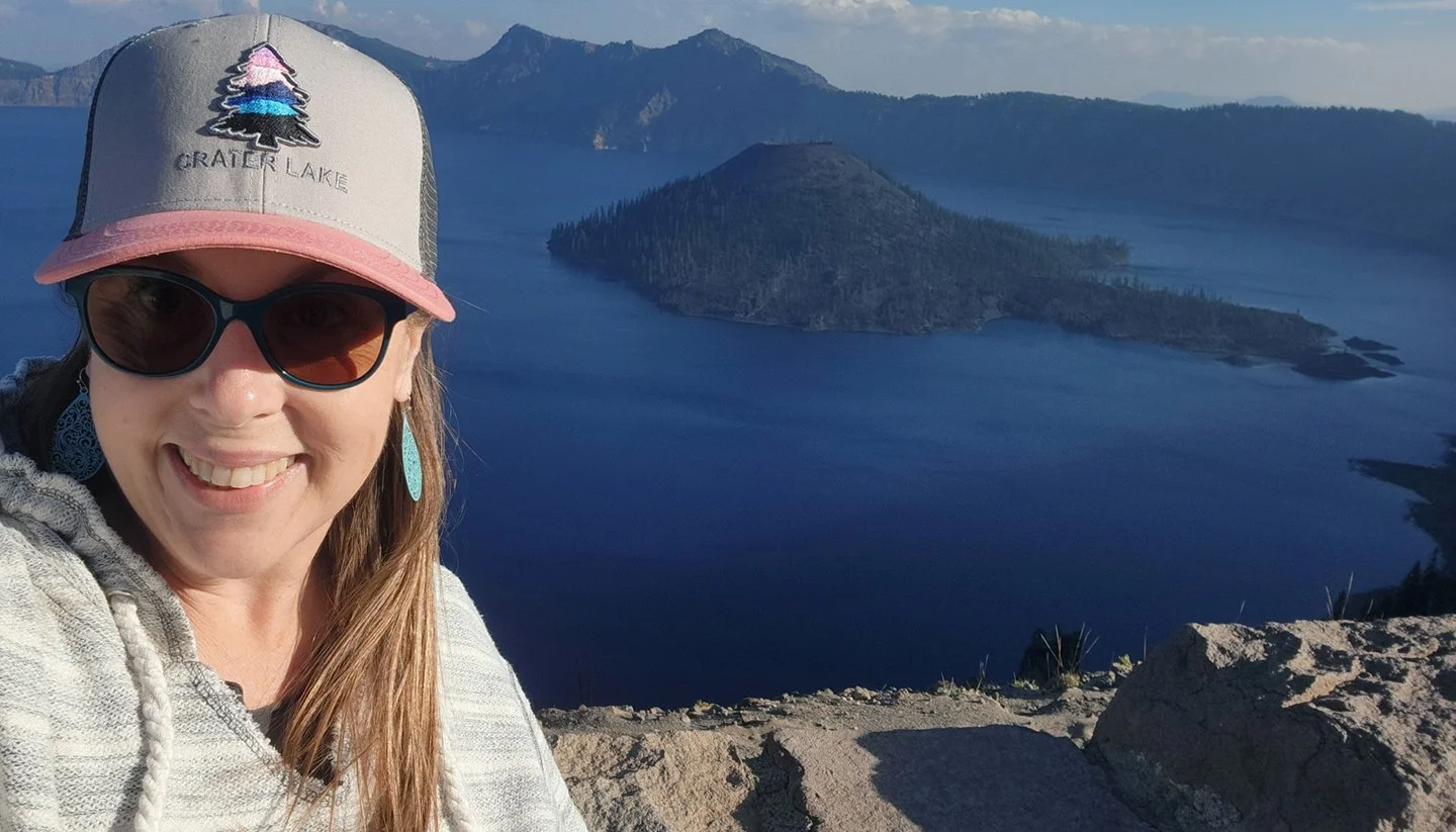 Joanna of the Oregon chapter of Girl Camper posing for a photo at Crater Lake National Park in Oregon
