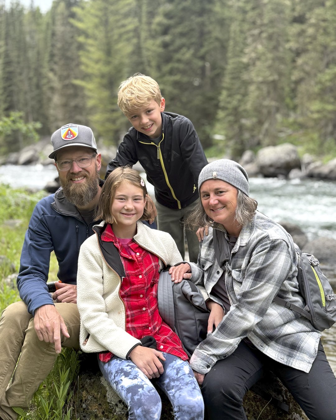 Jay Cullis of Airstream, posing for a family portrait along a river