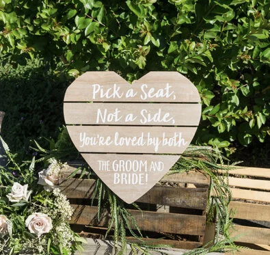 Heart shaped wooden Pick a Seat Not a Side sign