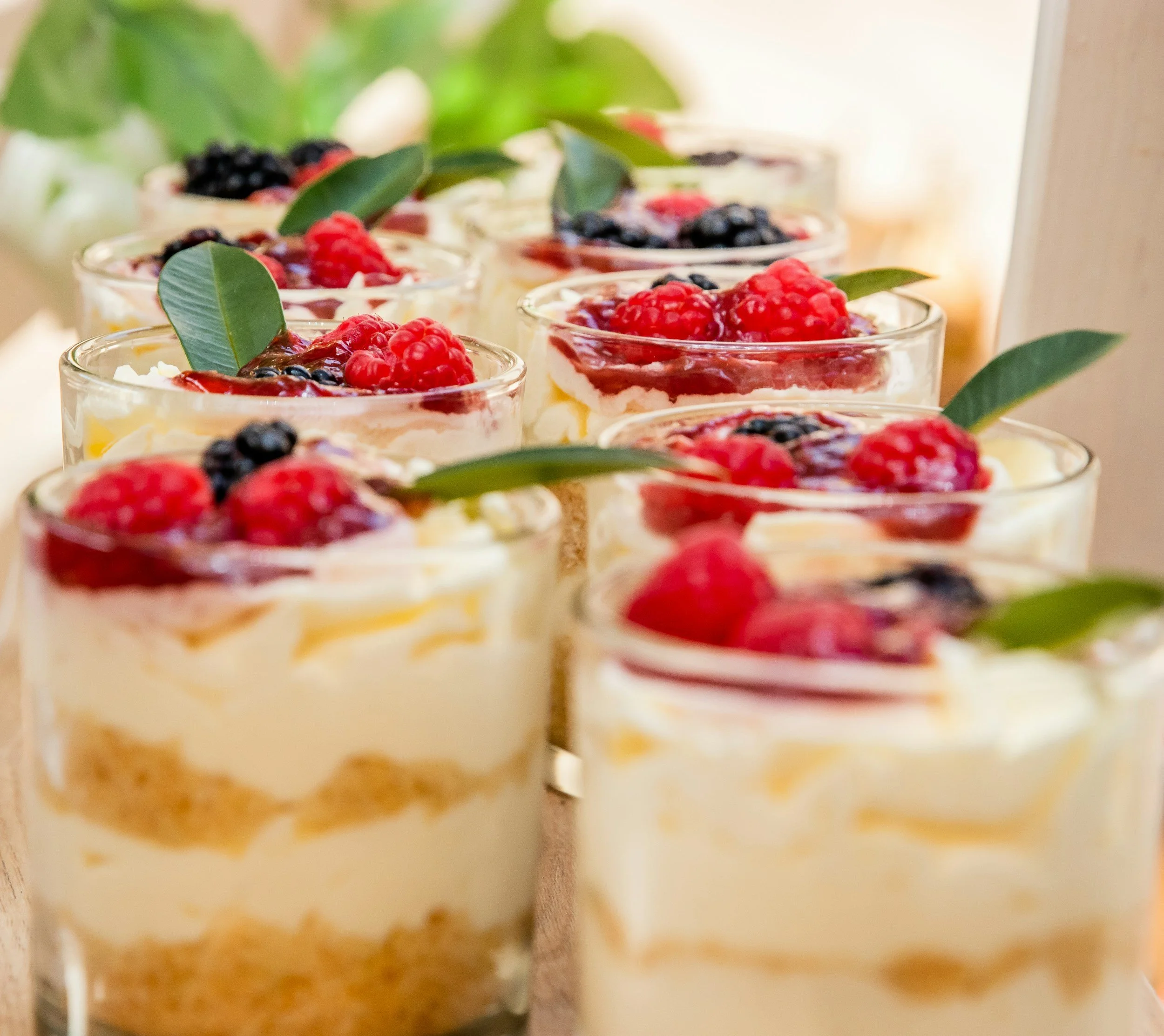 layered dessert cups with lemon cream, fresh berries and mint