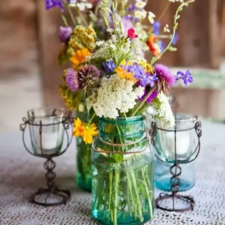 blue mason jar with flowers table centepiece