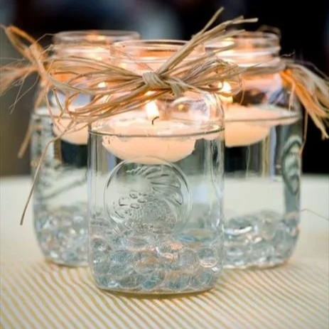 twine wrapped pint jar with floating candle wedding centerpiece
