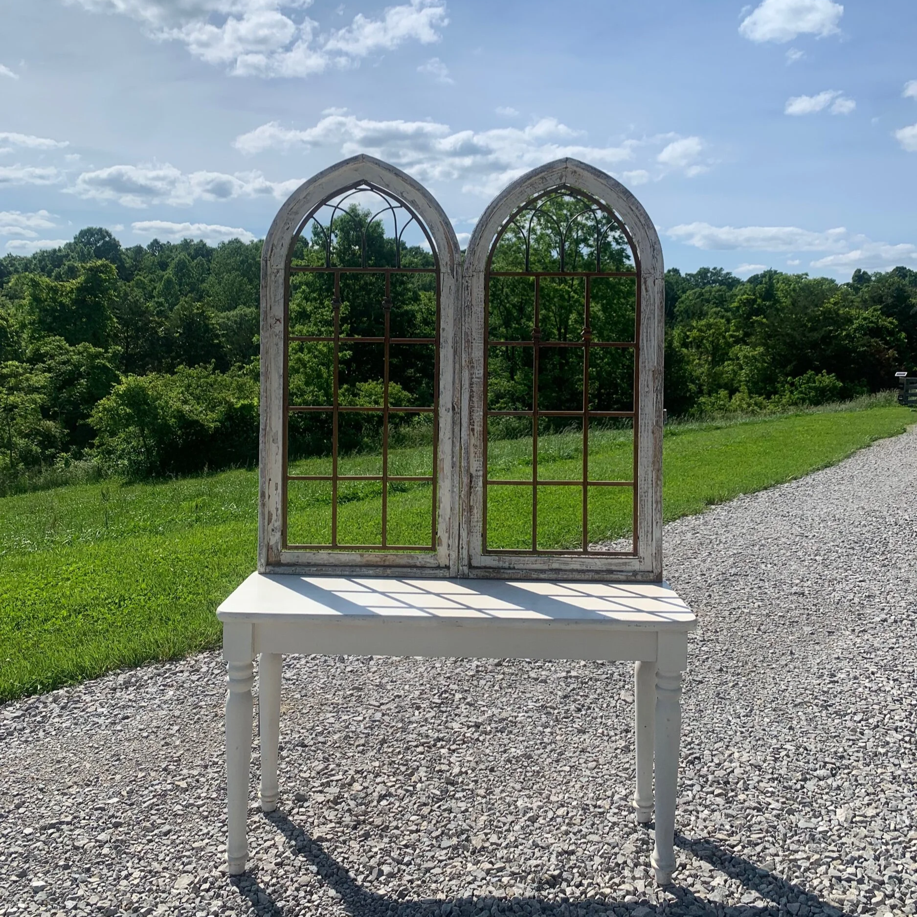 architectural salvage distressed arched windows combined with a table to create a unique rustic piec