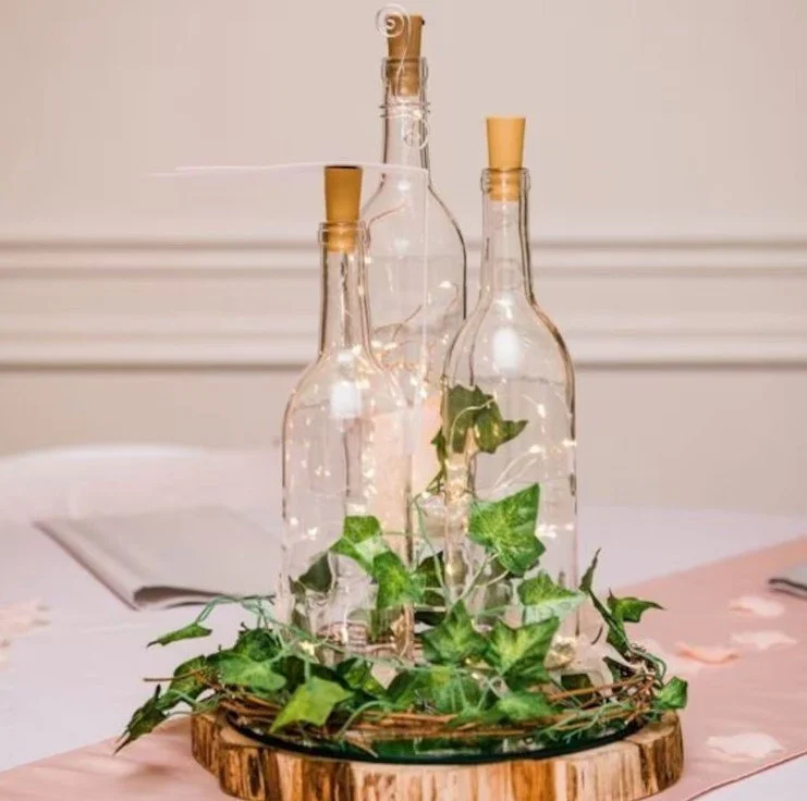 wine bottle centepiece with fairy lights.jpg