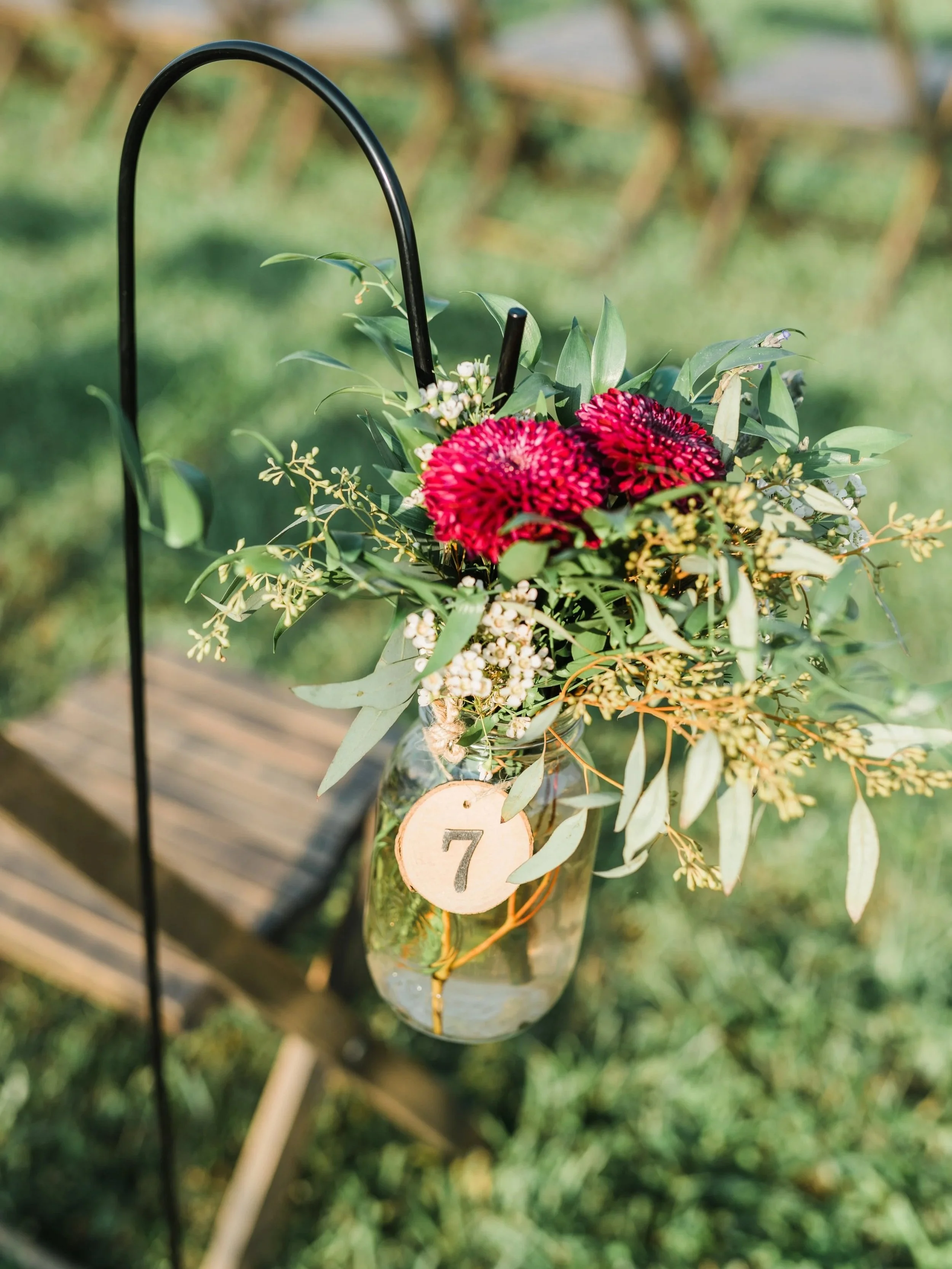 black shepherd's hook with hanging mason jar for wedding aisle marker