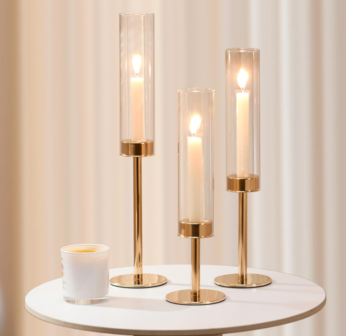 Gold modern candle holder trio with glass shade.png