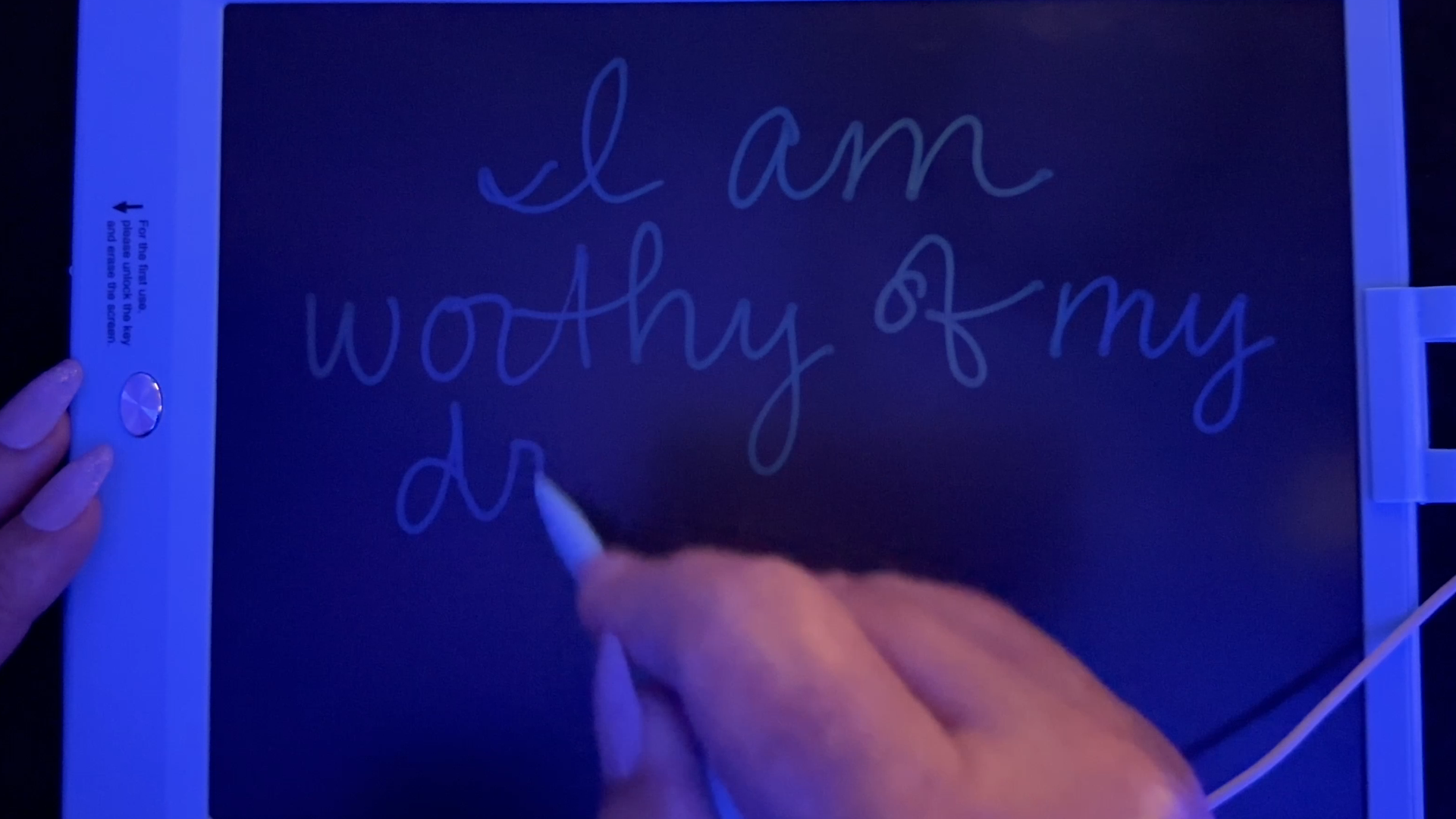 Writing ASMR close-up of handwritten affirmation "I am worthy of my dreams" on an LCD writing tablet with soft pen sounds, no talking, and calming blue ambient lighting.