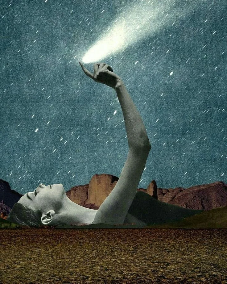 A surreal image of a woman’s face and arm emerging from the ground, holding a flashlight that illuminates the starry night sky. The background features mountains and a star-filled sky.