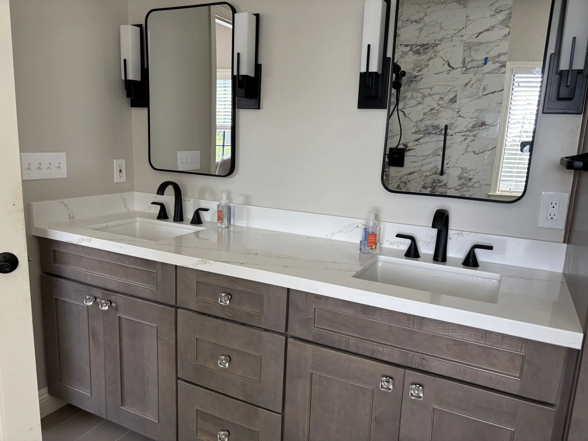 Installed mirrors, sconces, fabricated countertop for vanity & installed new vanity. 