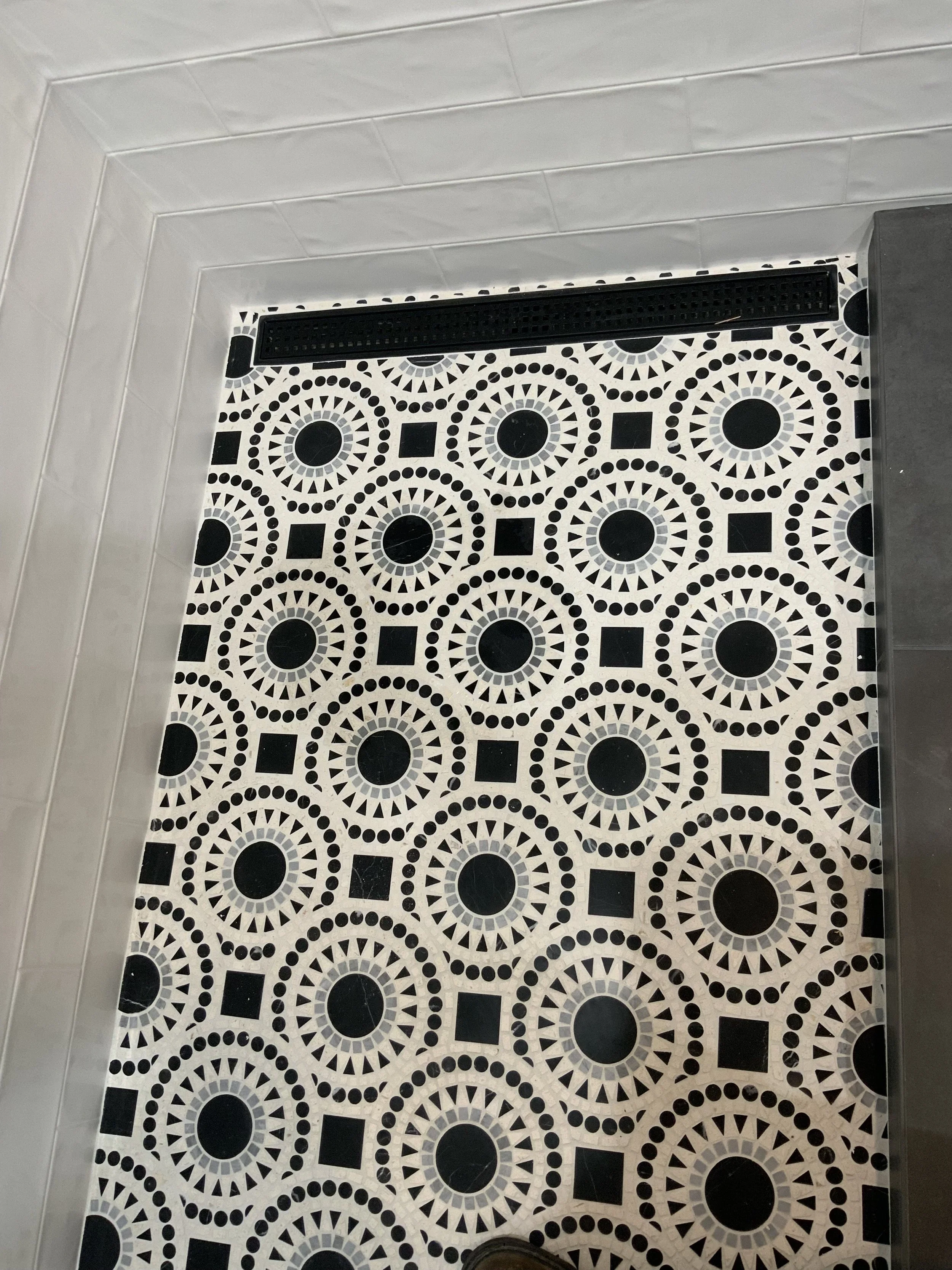 Shower floor tiled with linear shower drain