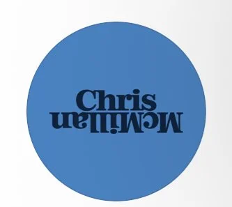 Blue circle with the name 'Chris MacMillan' written inside, with the text upside down.