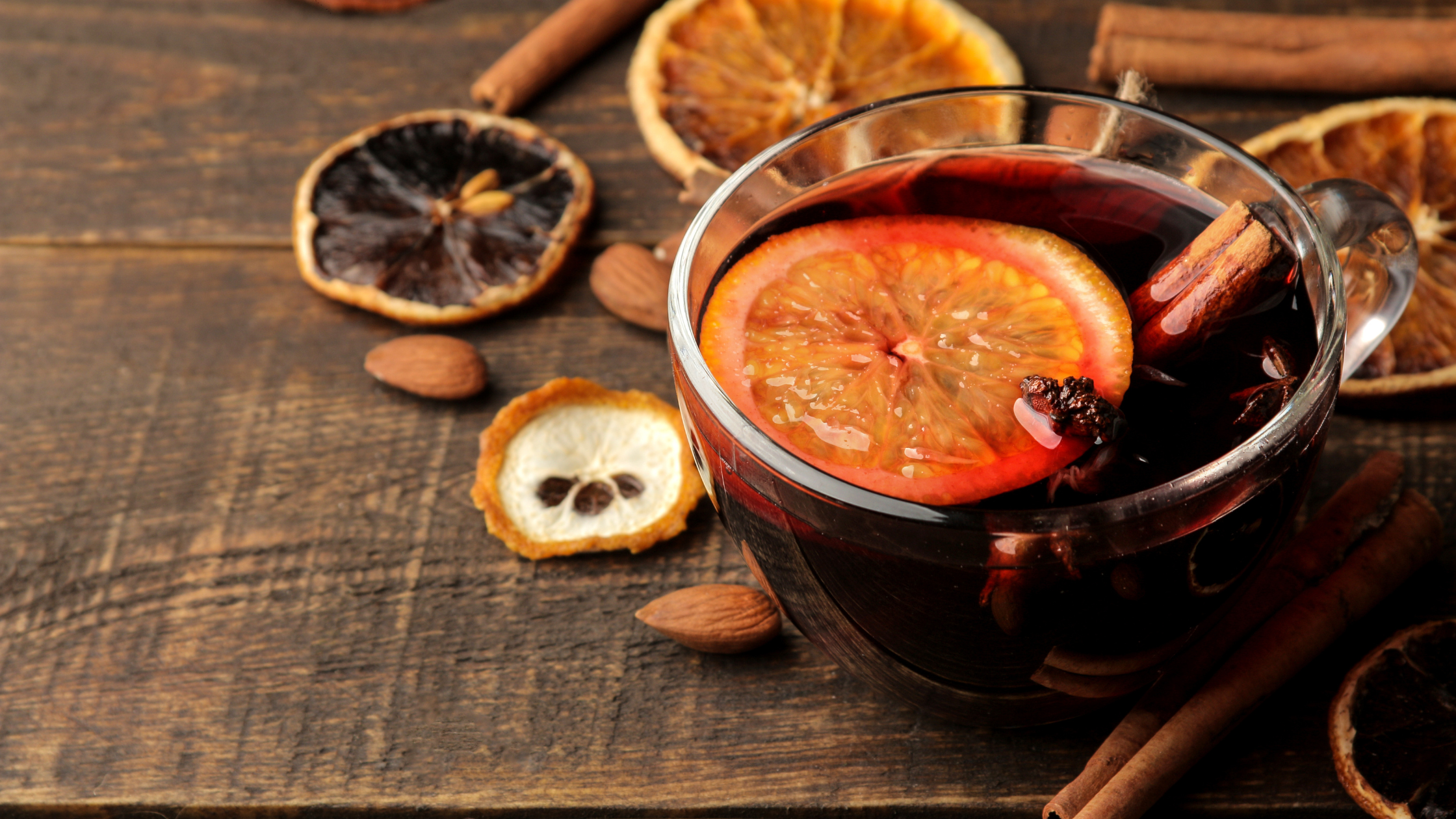 Mulled wine made with Artelium Cabaret Noir and Collaborators Brandy, served in festive glass mugs with orange slices and cinnamon