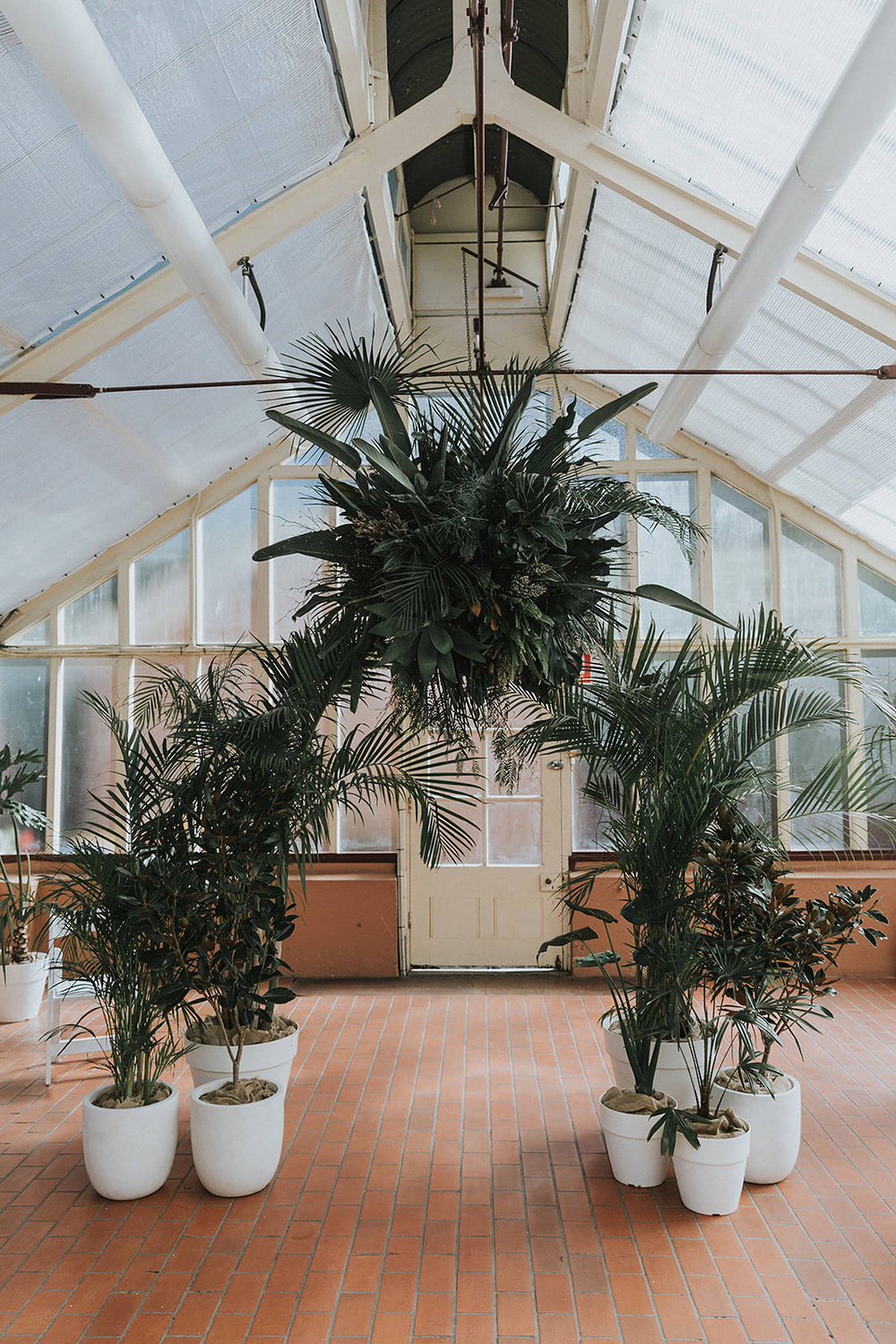 green tropical palm wedding ceremony backdrop at sydney garden