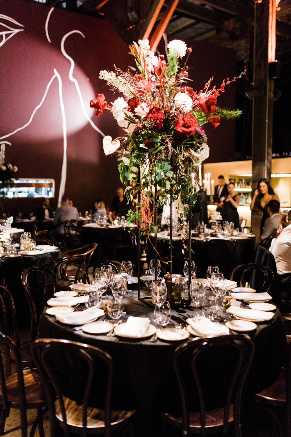 tall table flowers on stands in rushcutters bay at bar m restaurant